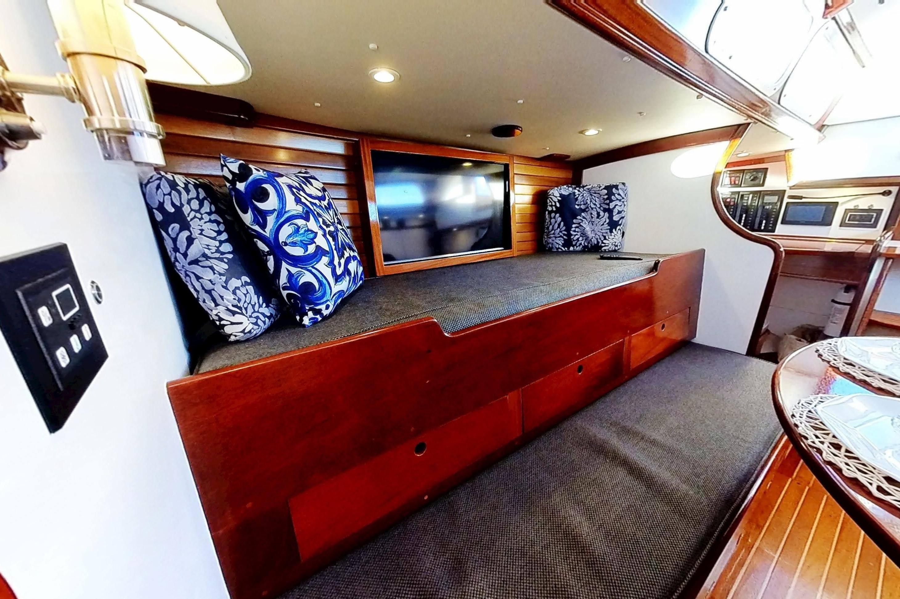 Interior of 1970 Hinckley Bermuda 40 yacht with cozy seating and nautical decor.