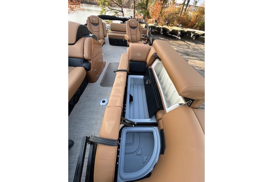 2025 Regency 230 LE3 Sport boat interior with tan seating and storage compartments open.