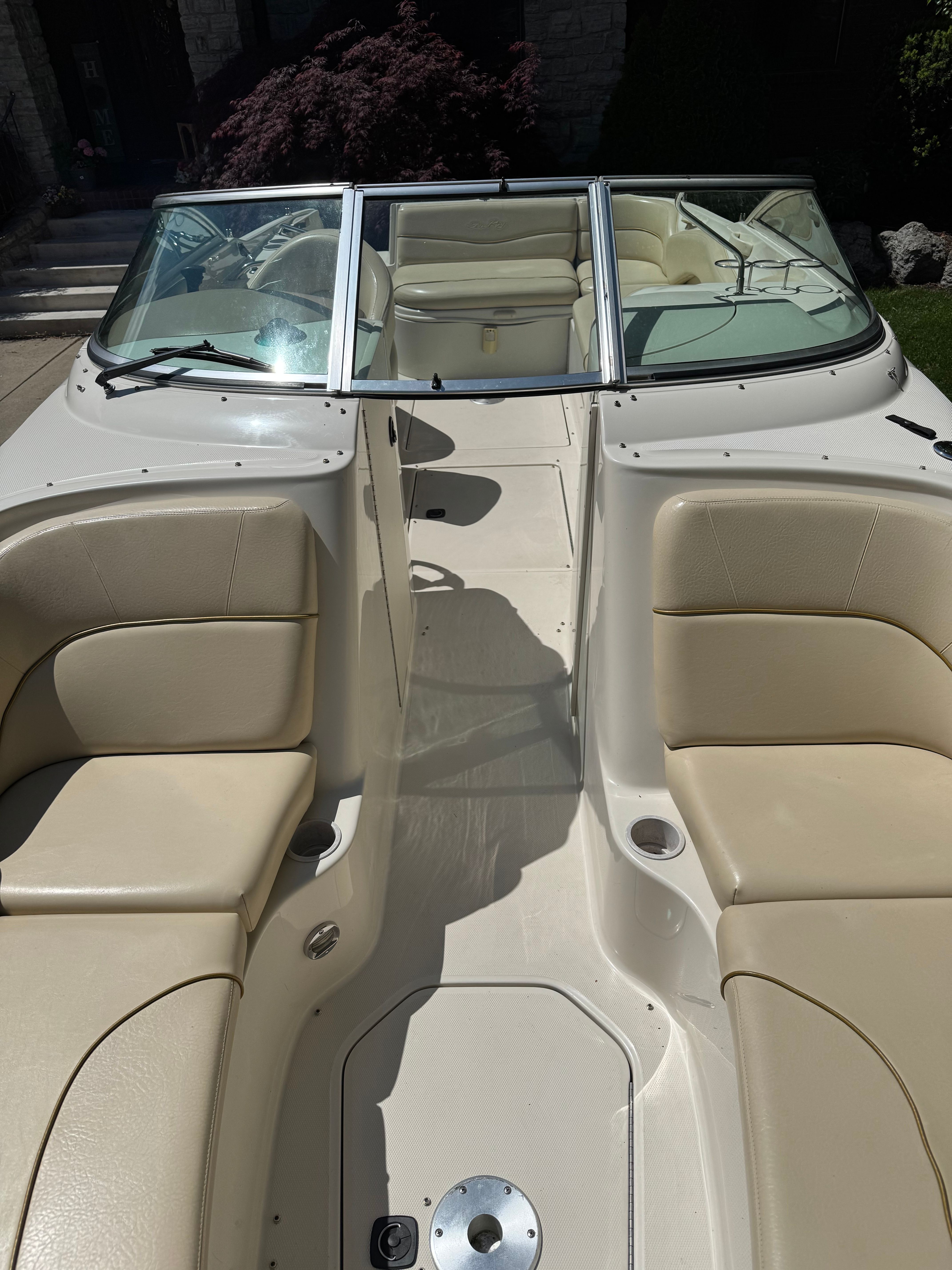 Interior view of a 2001 Sea Ray 240 Sundeck boat with beige seating.
