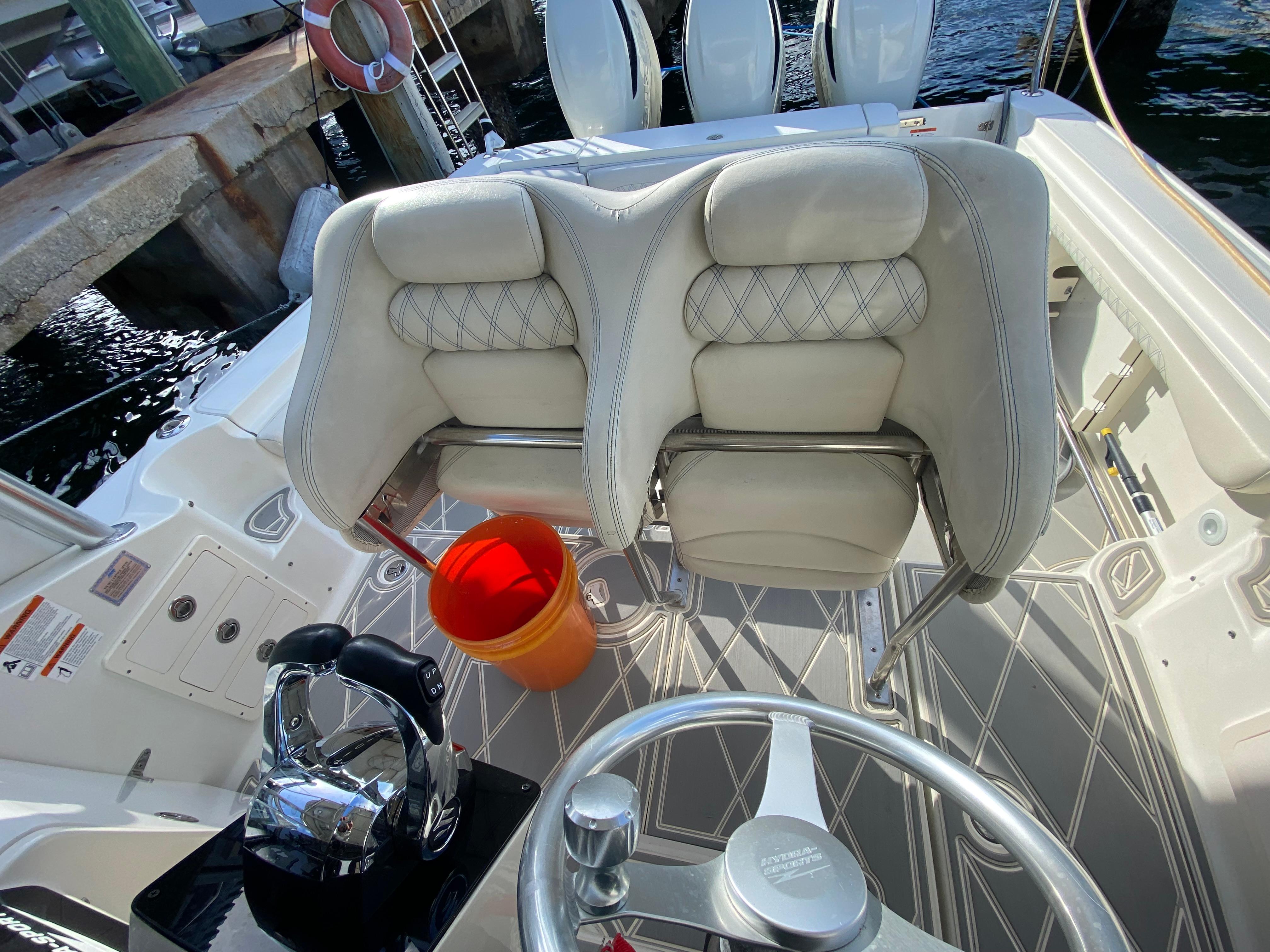 2006 Hydra-Sports Vector 3300 VX boat interior with helm, seats, and orange bucket.