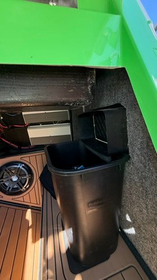 Interior of a 2018 Nautique Super Air Nautique G23 with green accent and speaker.