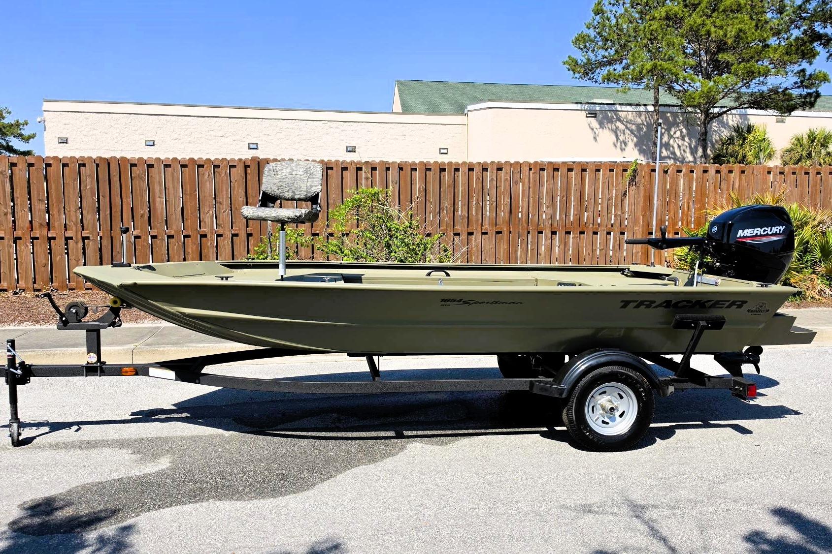2026 Tracker Grizzly 1654 T Sportsman boat with Mercury engine on trailer.
