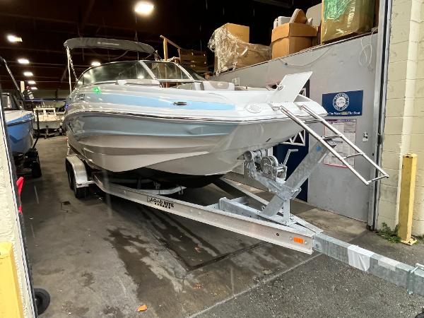2023 Crownline Eclipse E235 XS boat on trailer in indoor storage.
