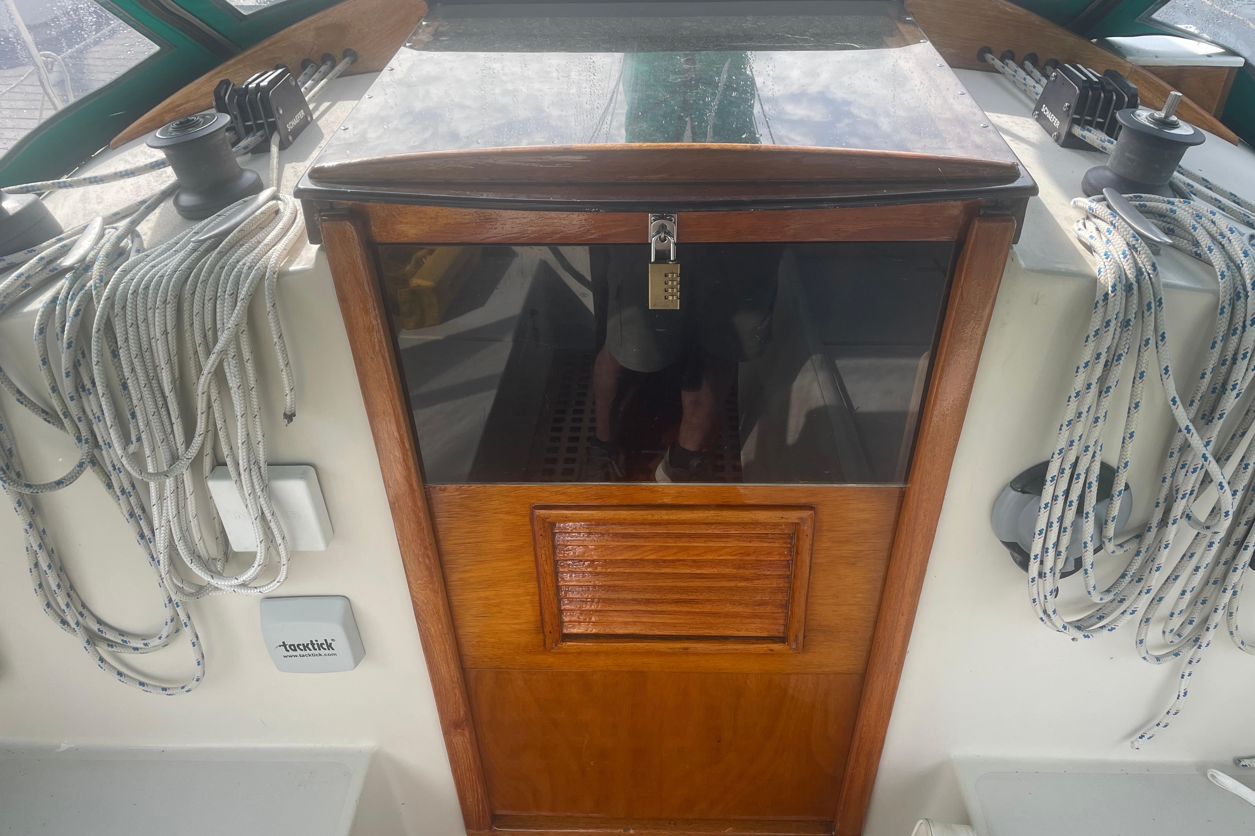 Cockpit of 1981 Nonsuch 30 Classic sailboat with ropes and wooden hatch.