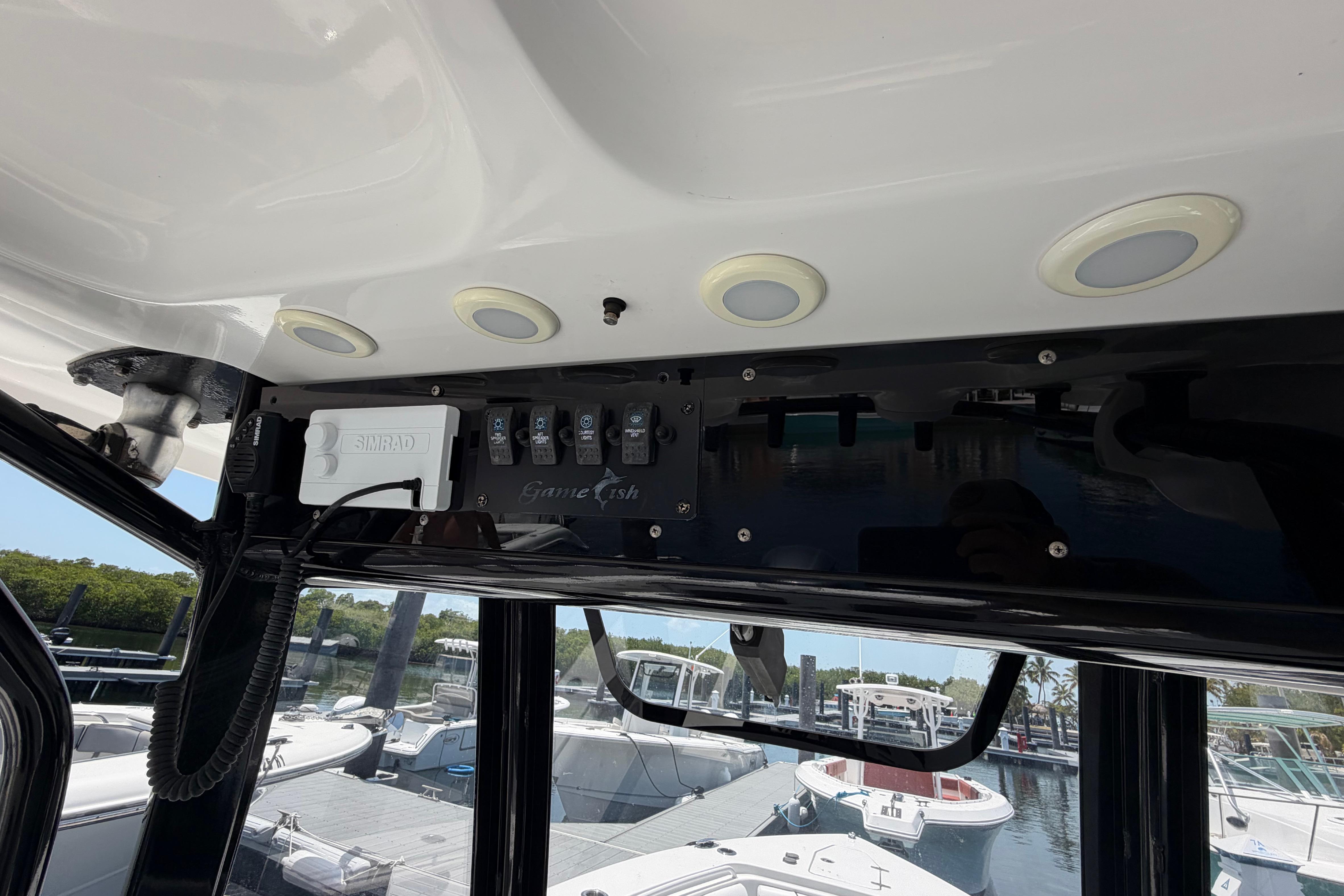 Control panel of a 2019 Sea Hunt Gamefish 27 Coffin Box boat at a marina.