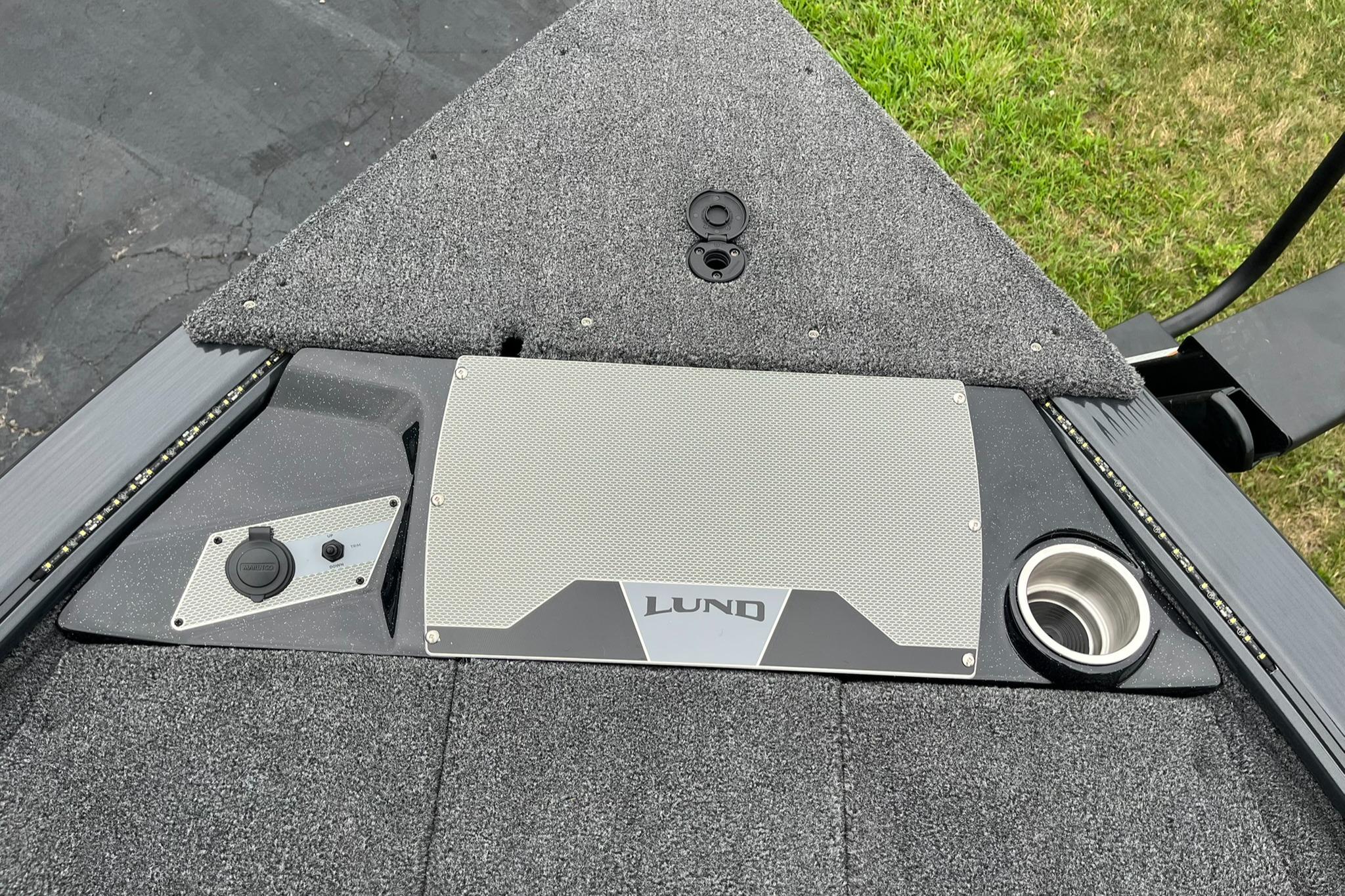 2026 Lund 1875 Pro-V Bass XS boat deck with storage and cup holder.