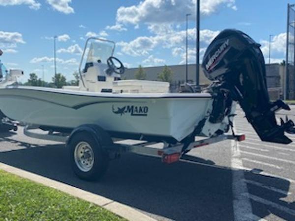 2024 Mako Pro Skiff 15 CC boat on trailer with Mercury outboard motor.