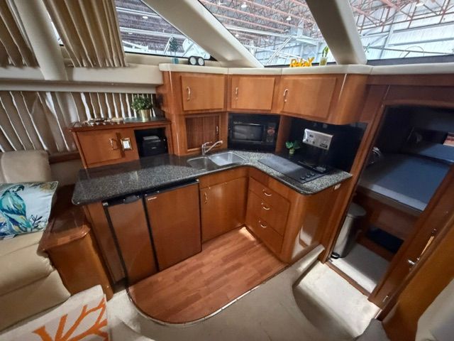 Interior of the 2005 Carver 44 Cockpit Motor Yacht featuring a kitchen and seating area.
