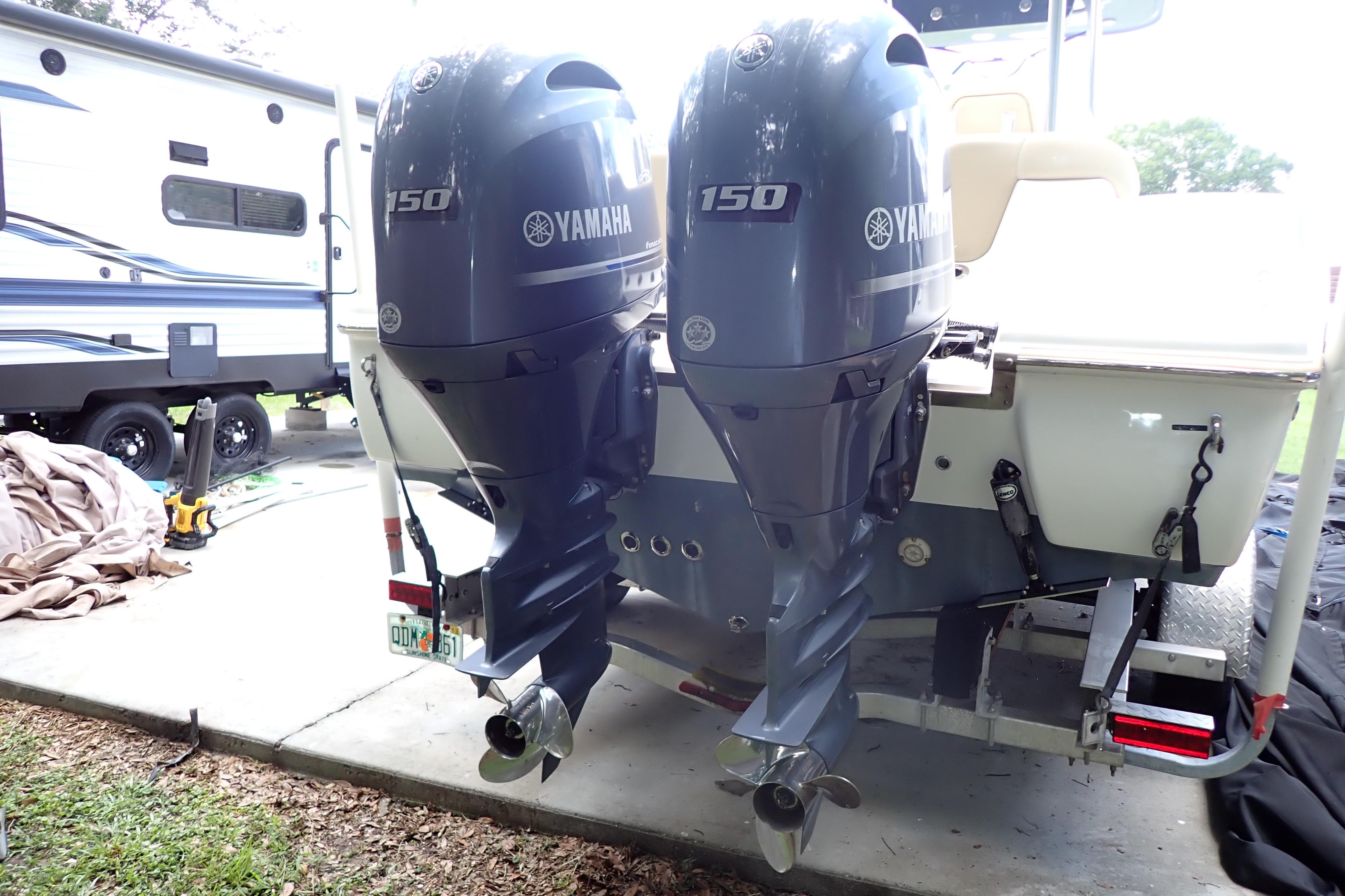 2019 Key West 263 FS boat with dual Yamaha 150 outboard motors in a driveway.