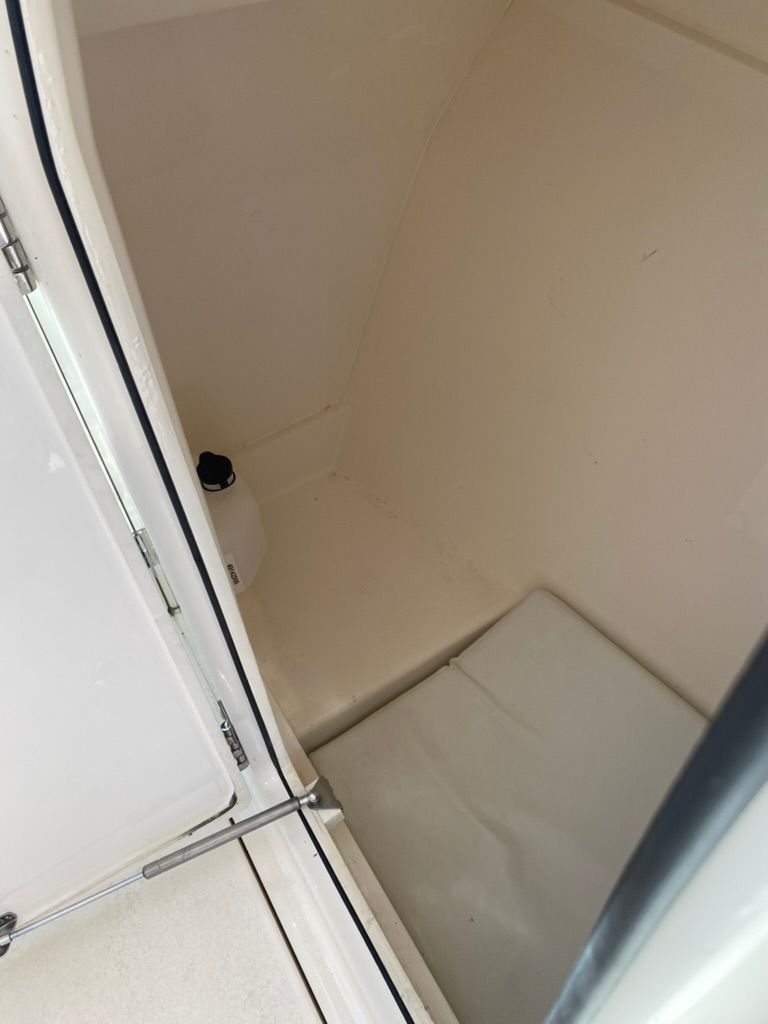Interior of a 2023 Cobia 330 boat, white interior.