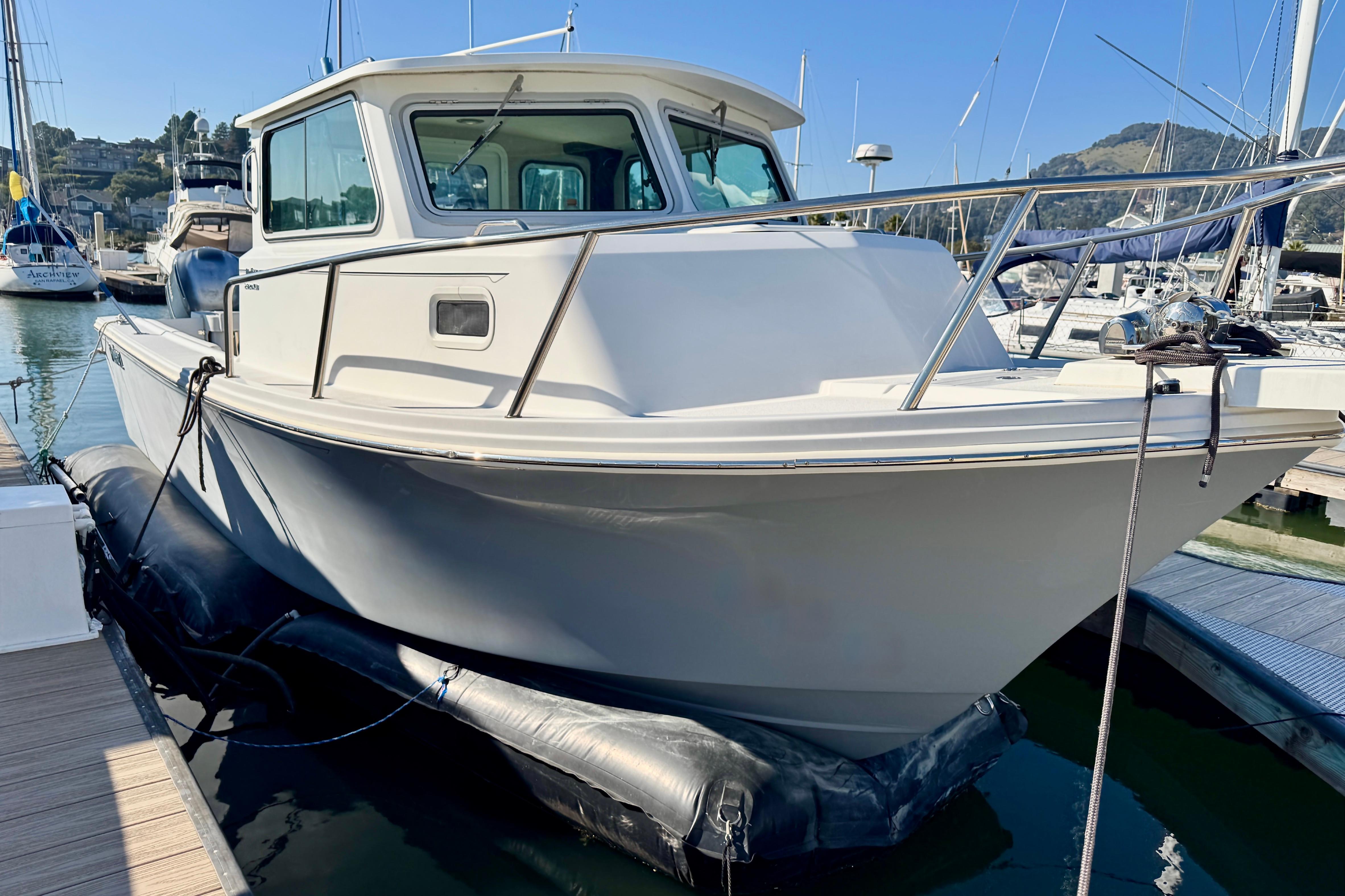 2021 Parker 2820 XLD Sport Cabin boat docked in a marina.