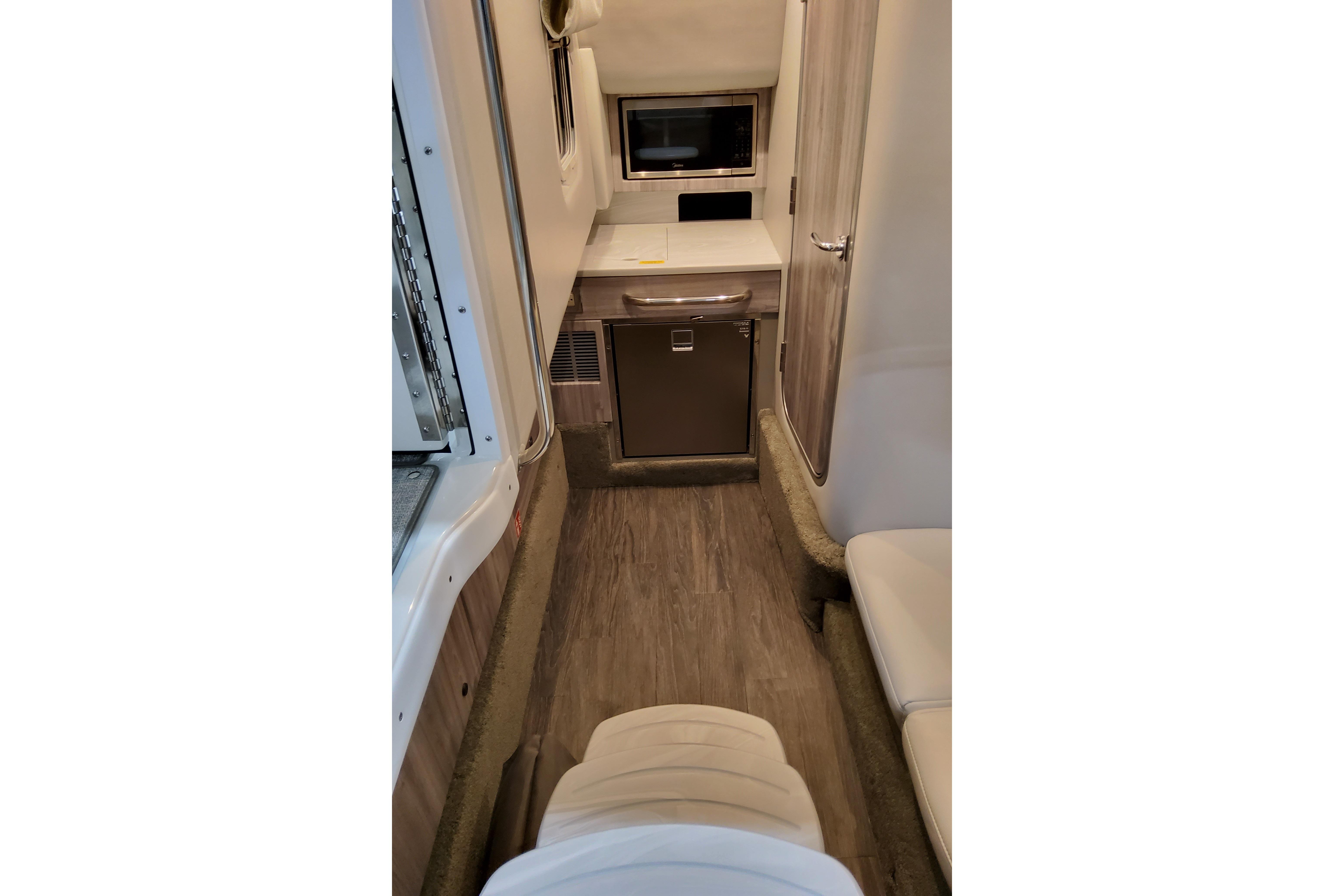 Interior of 2027 Formula 350 Crossover Bowrider I/O, featuring modern kitchenette and seating.