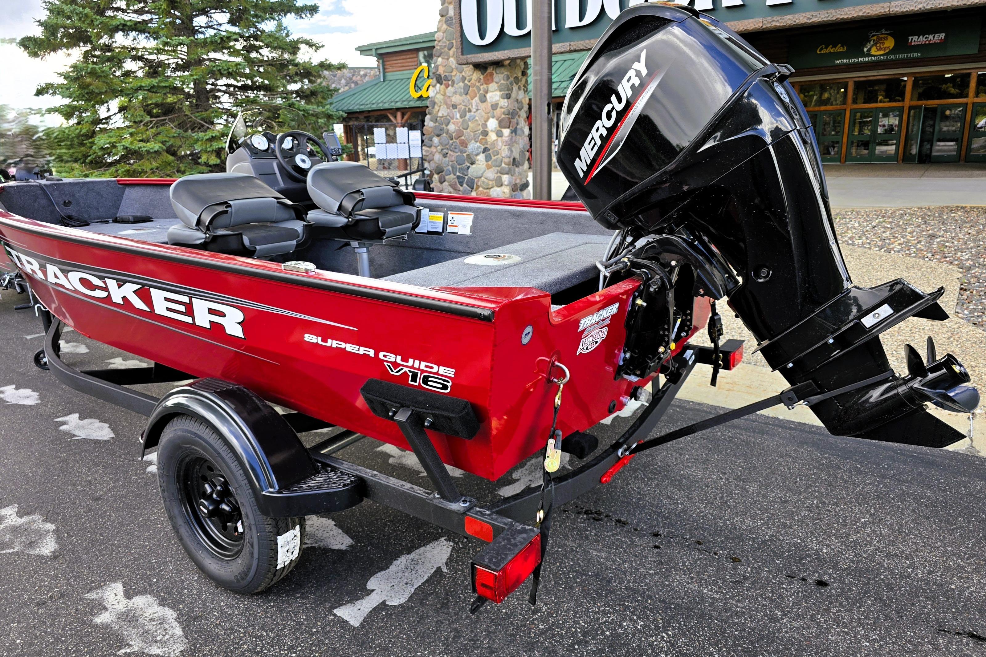 2026 Tracker Super Guide V-16 SC boat with Mercury engine, parked outdoors.