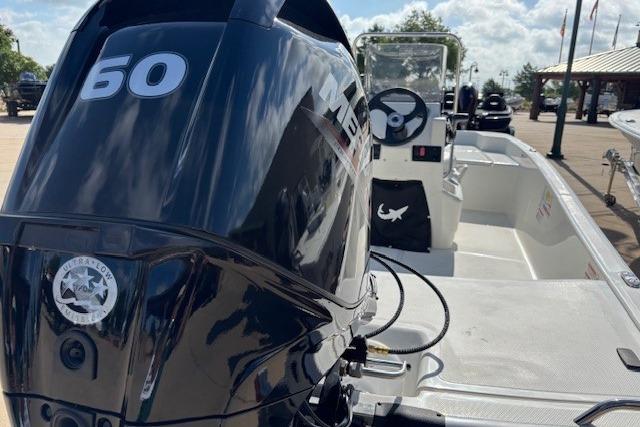2026 Mako Pro Skiff 15 CC with 60 HP engine, docked under clear skies.