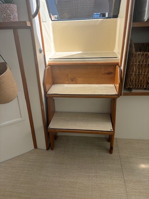 Wooden stairs inside a 1986 Sea Ray 360 Aft Cabin yacht.