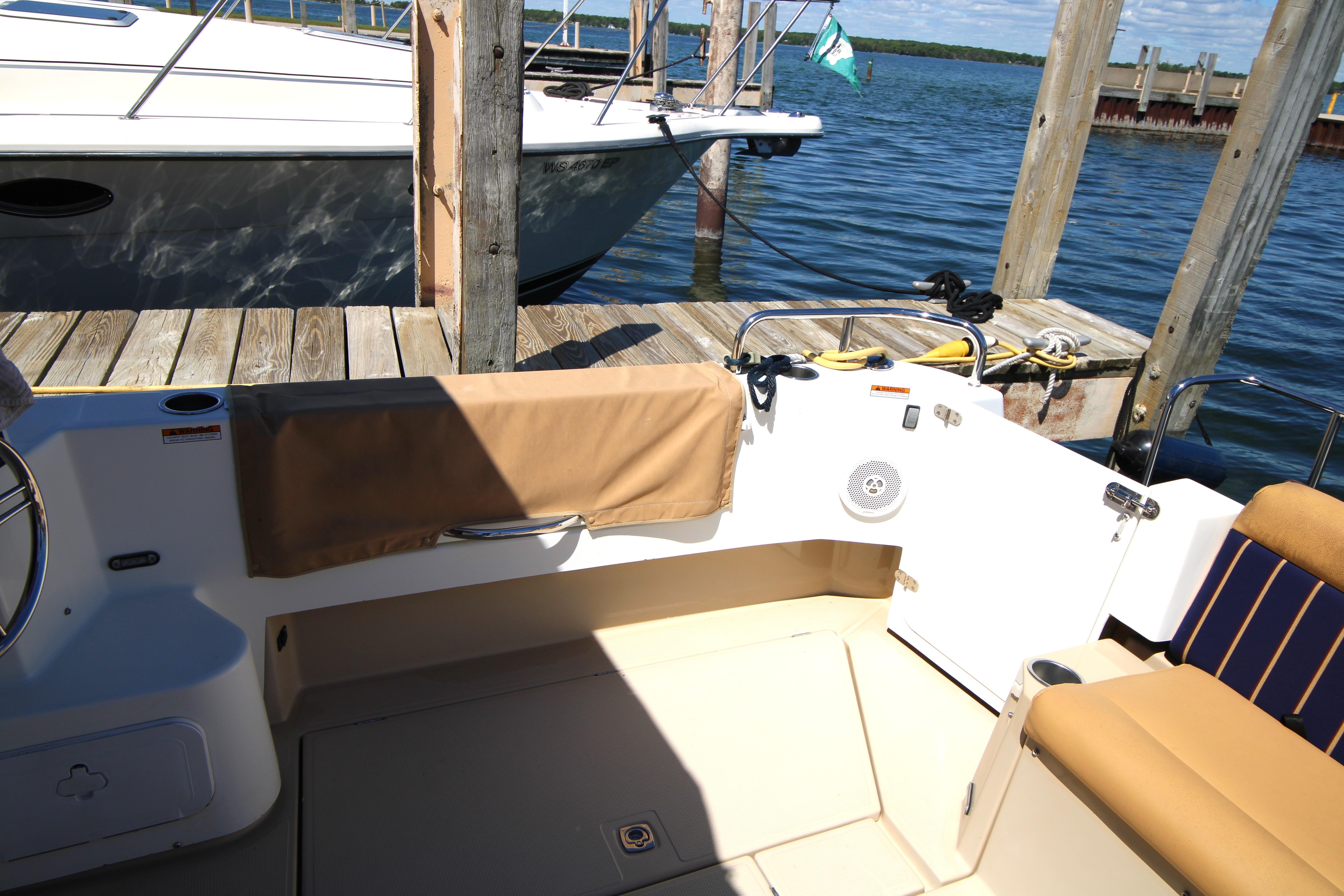 2013 Ranger Tugs R-31 CB boat docked, featuring a spacious cockpit and comfortable seating.