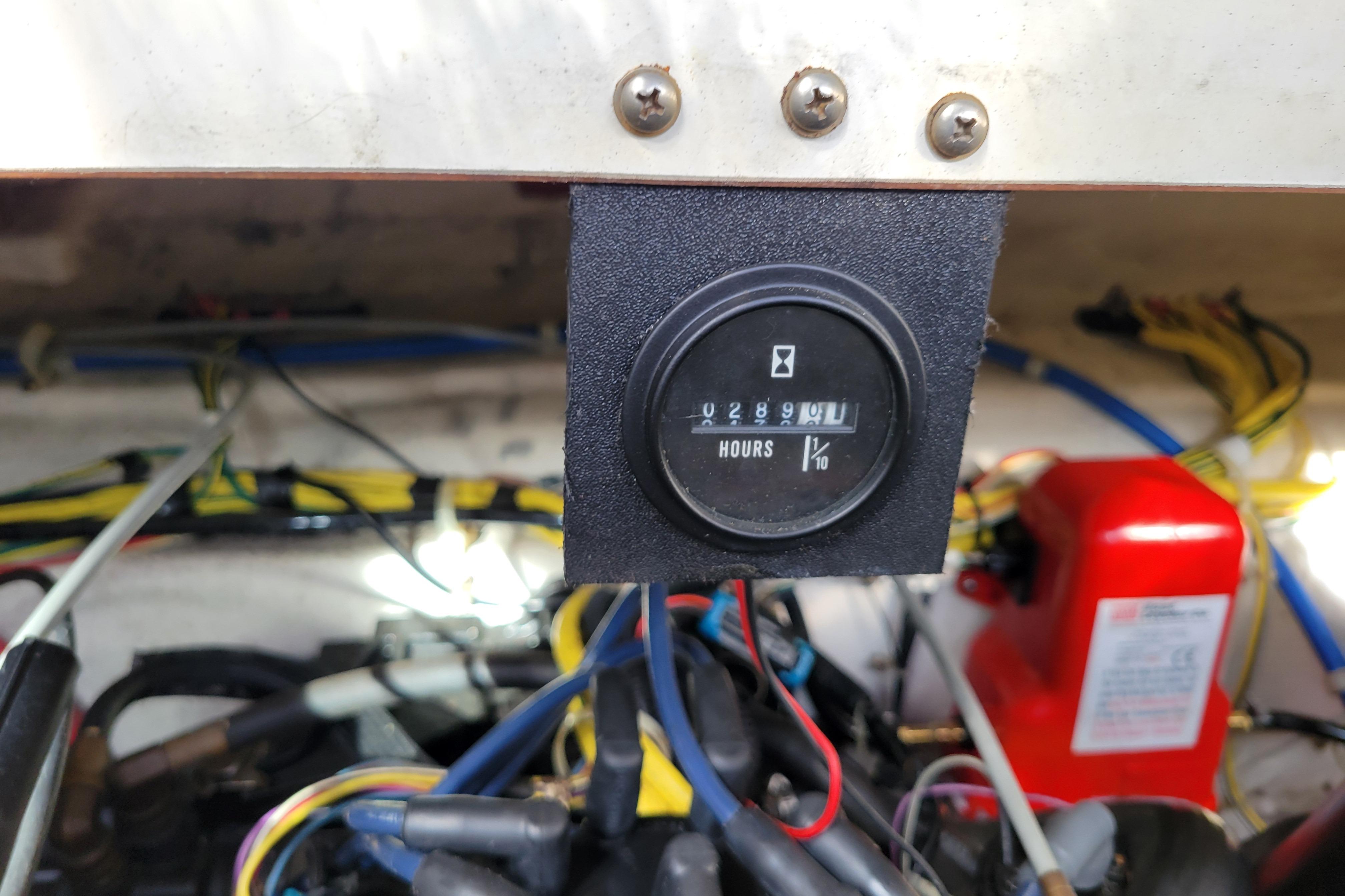 Hour meter display on 2007 Bayliner 245 Cruiser boat engine compartment.