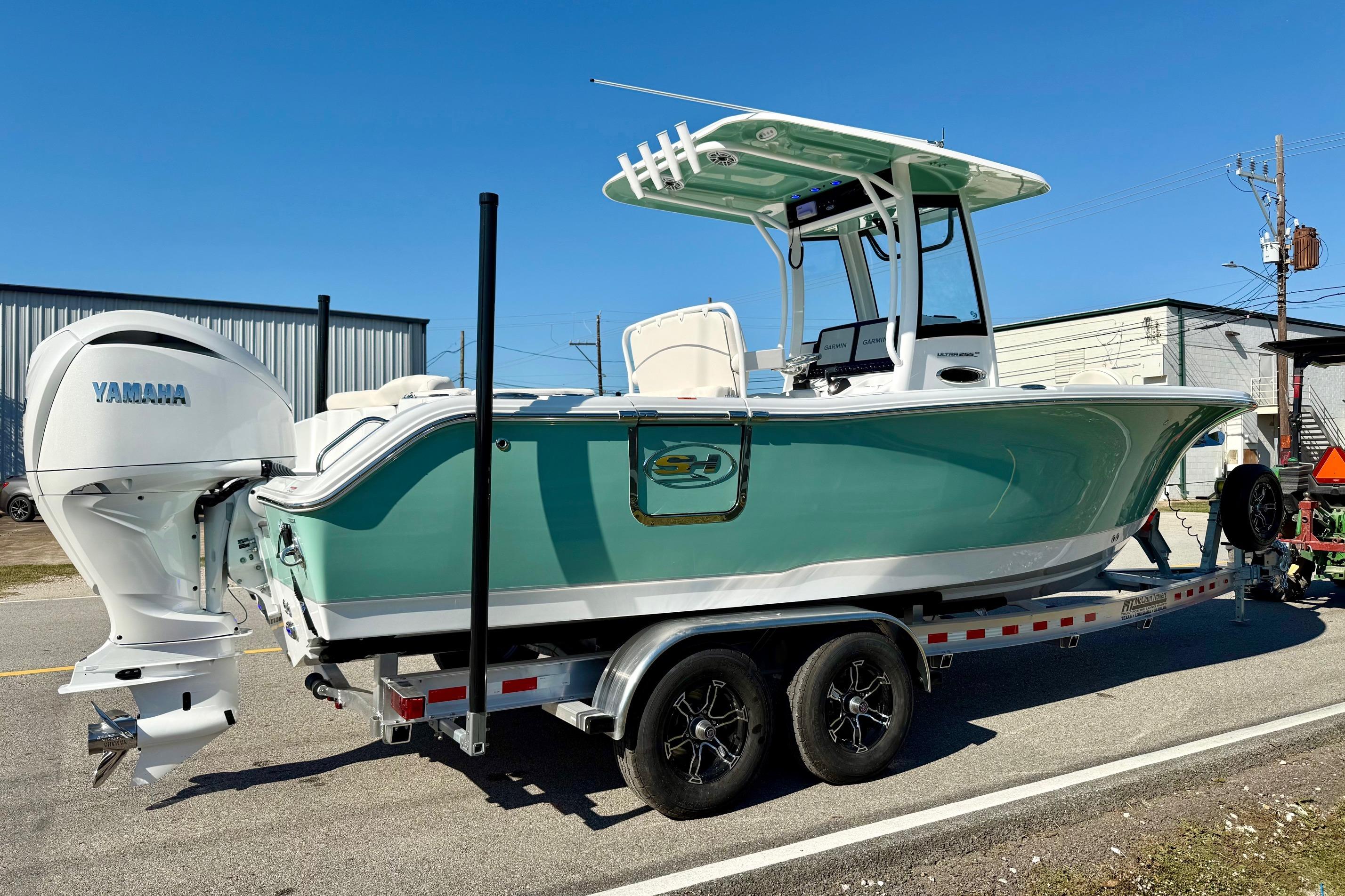 2026 Sea Hunt Ultra 255 SE boat on trailer, featuring Yamaha engine, parked outdoors.