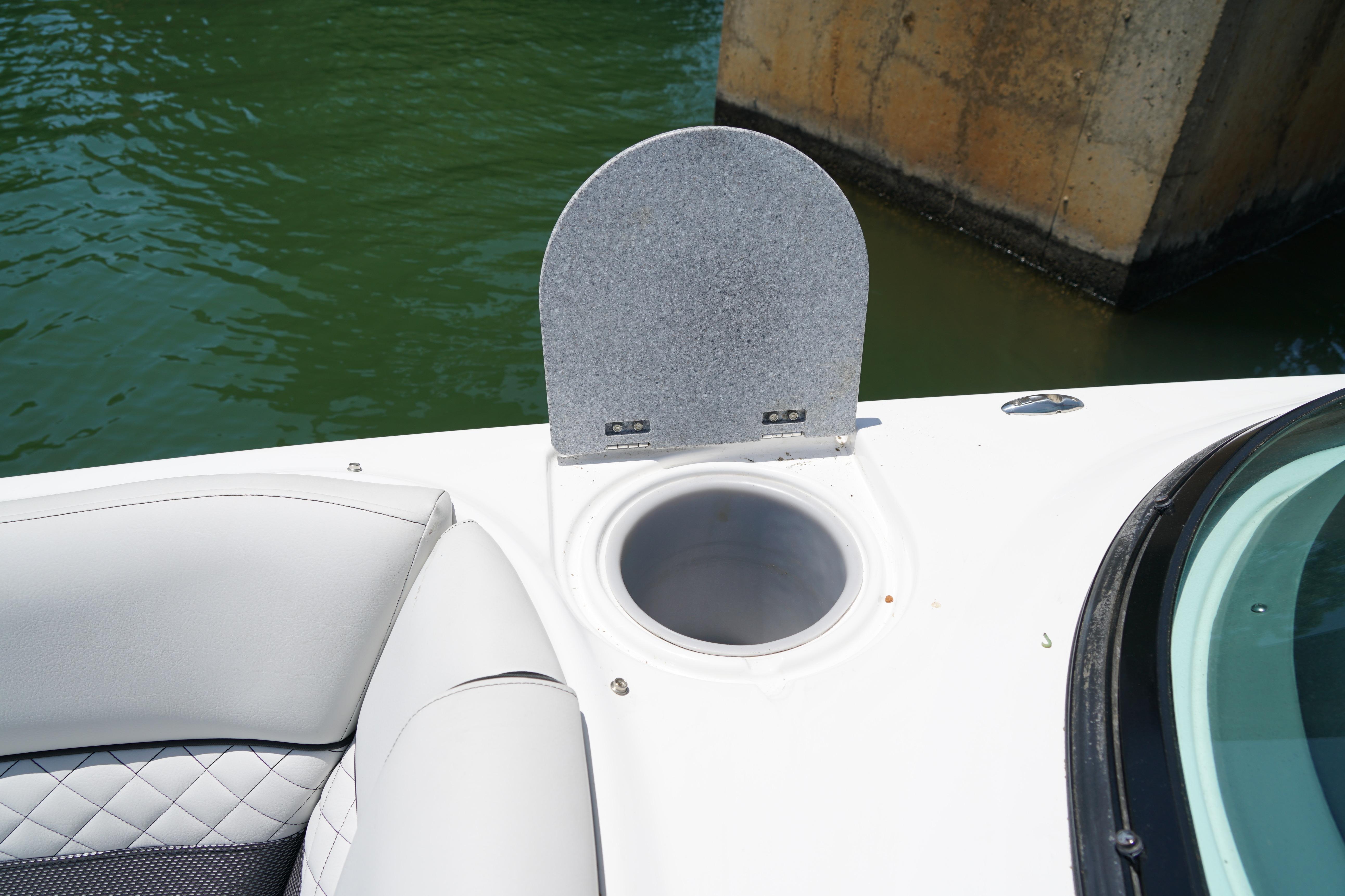 2020 Hurricane SunDeck 2486 OB boat with cup holder and cushioned seating.