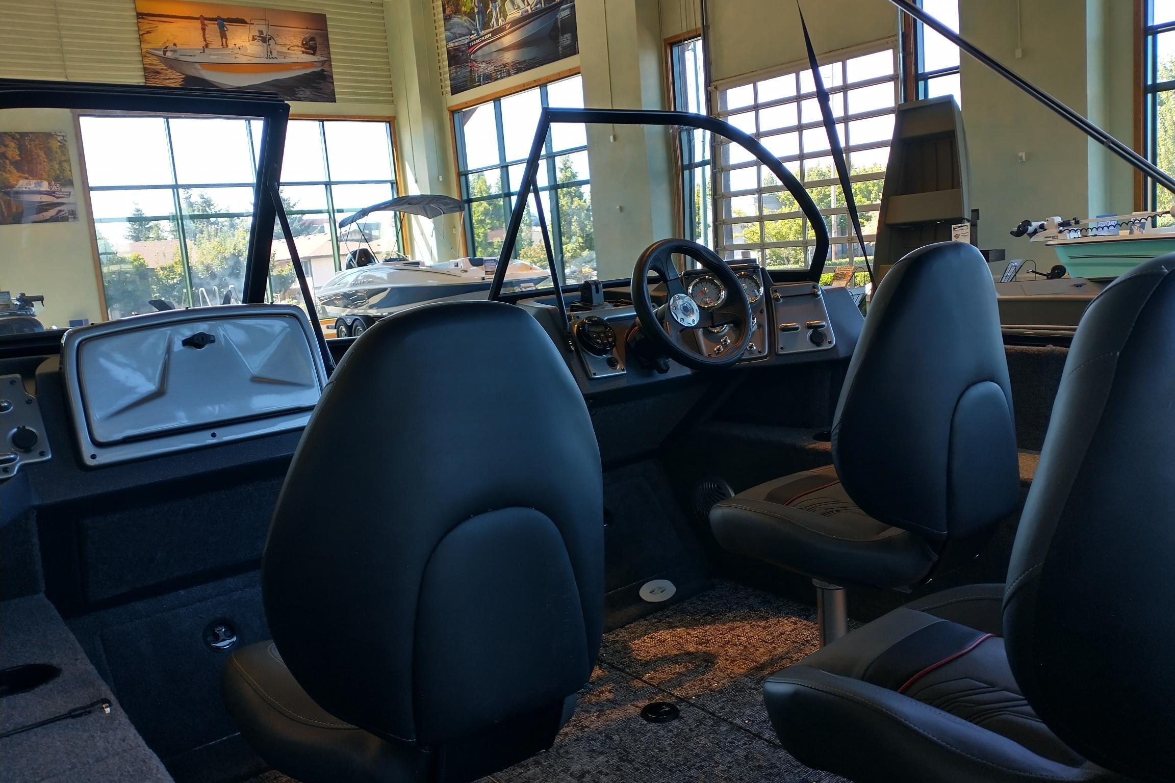 Interior of 2026 Tracker Pro Guide V-175 WT boat with steering wheel and seats.