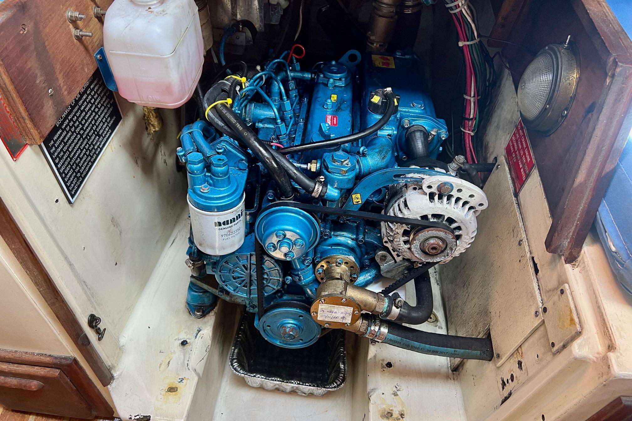 Engine compartment of a 1982 Pacific Seacraft 37 sailboat, featuring a blue marine engine.