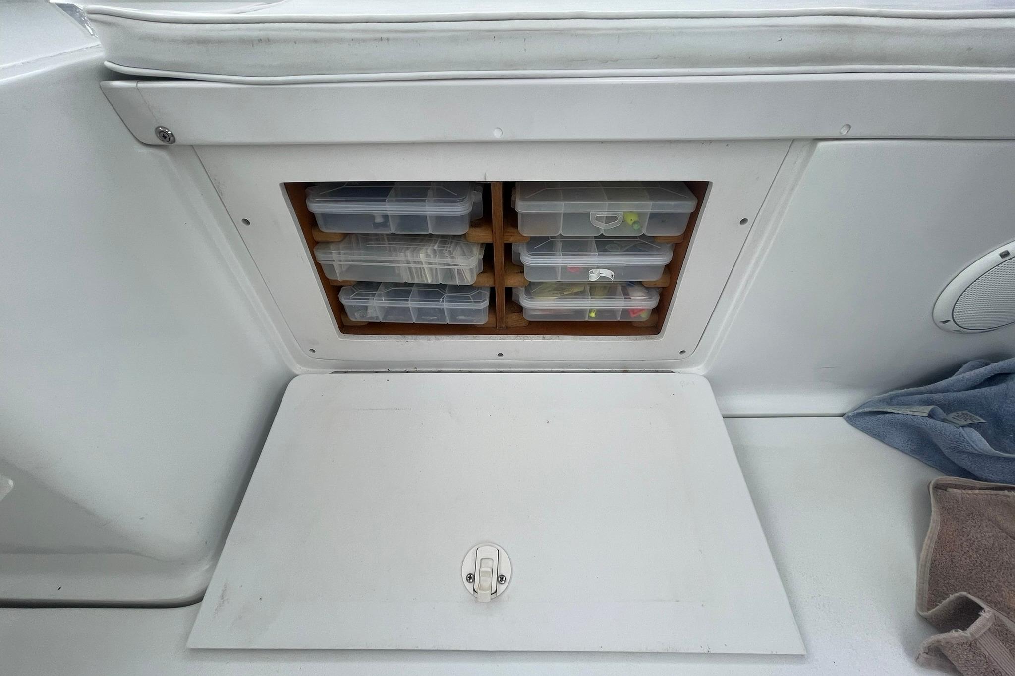 Storage compartment with tackle boxes on a 1996 Luhrs Tournament 290 Open boat.