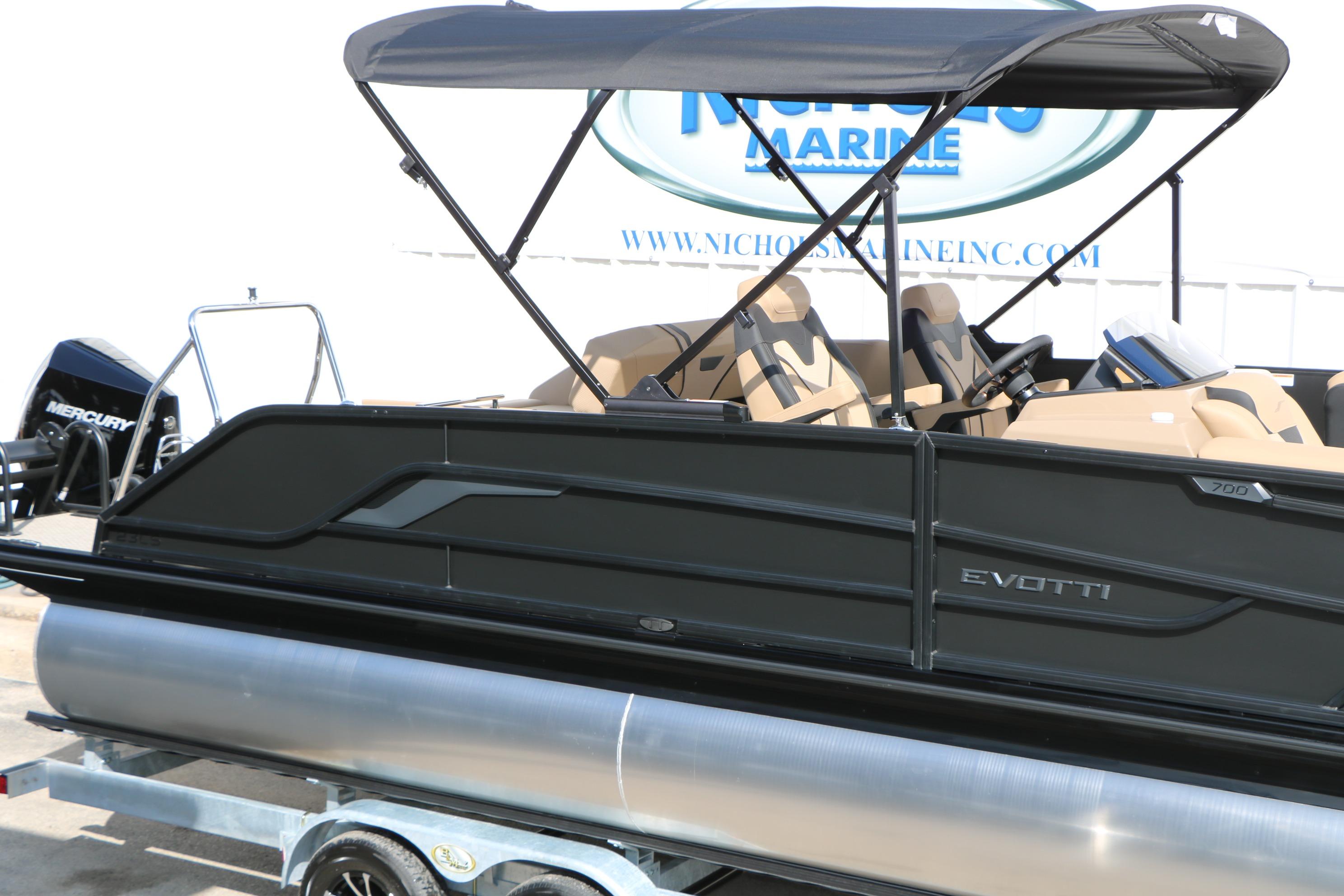 2026 Evotti 723CS pontoon boat with canopy and Mercury engine at dealership.