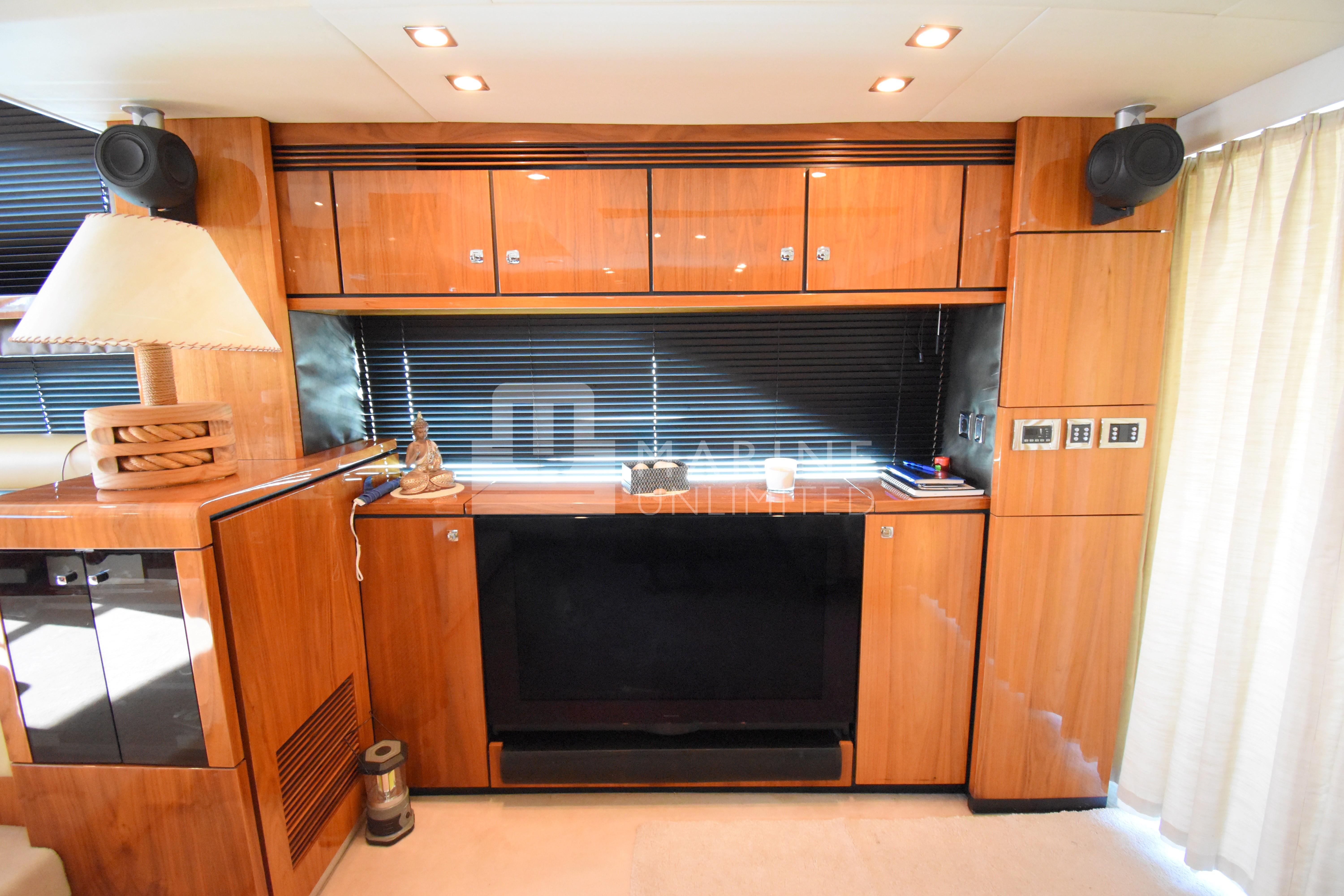 Luxurious interior of 2010 Fairline Squadron 55 yacht with wooden cabinetry and modern amenities.
