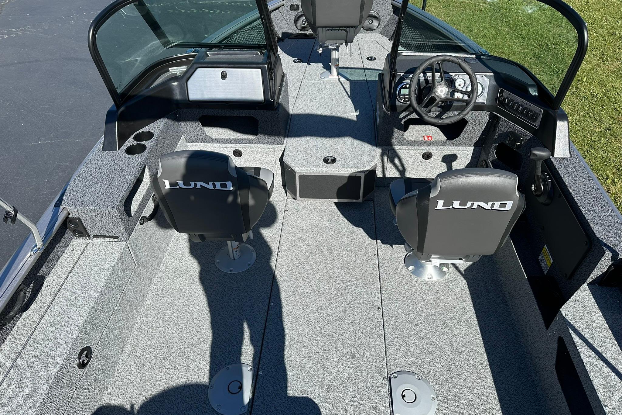 2026 Lund 1875 Impact XS Sport boat interior with seating and steering console.