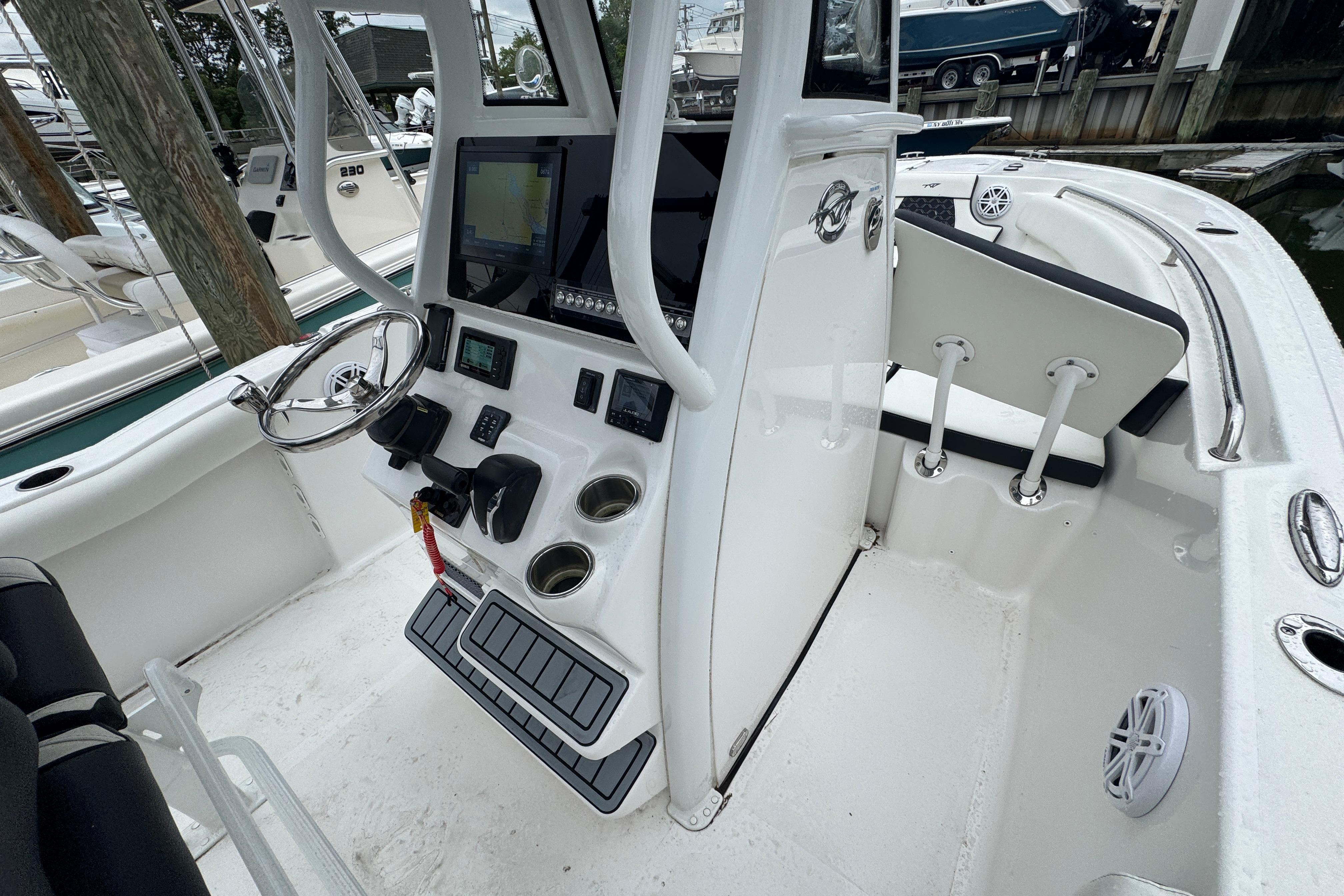 2022 Tidewater 232 SS boat interior with steering console and seating area.