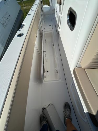 2023 Edgewater 340CC boat interior with storage compartments and seating.