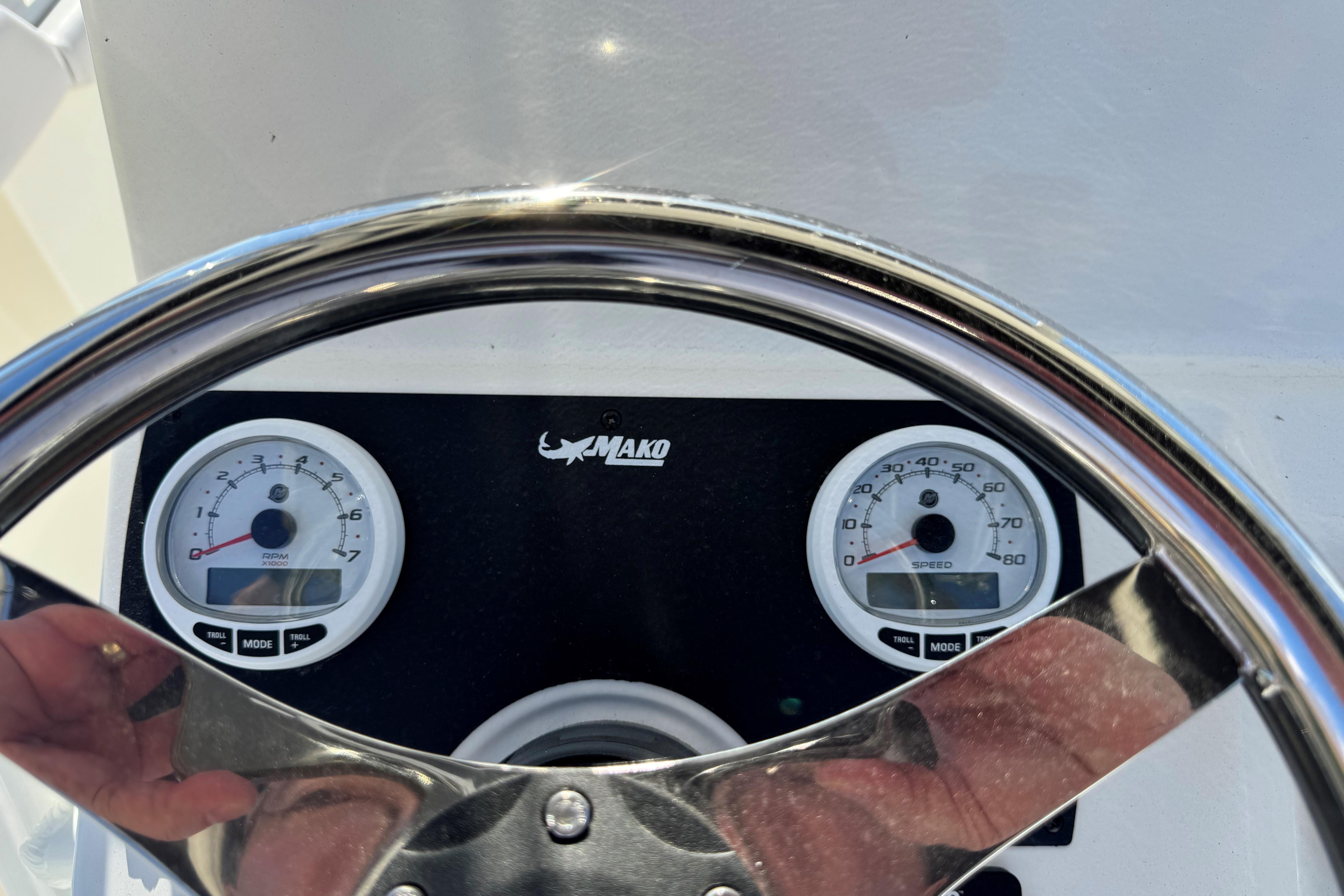 Steering wheel and gauges of 2026 Mako 214 Center Console boat dashboard.