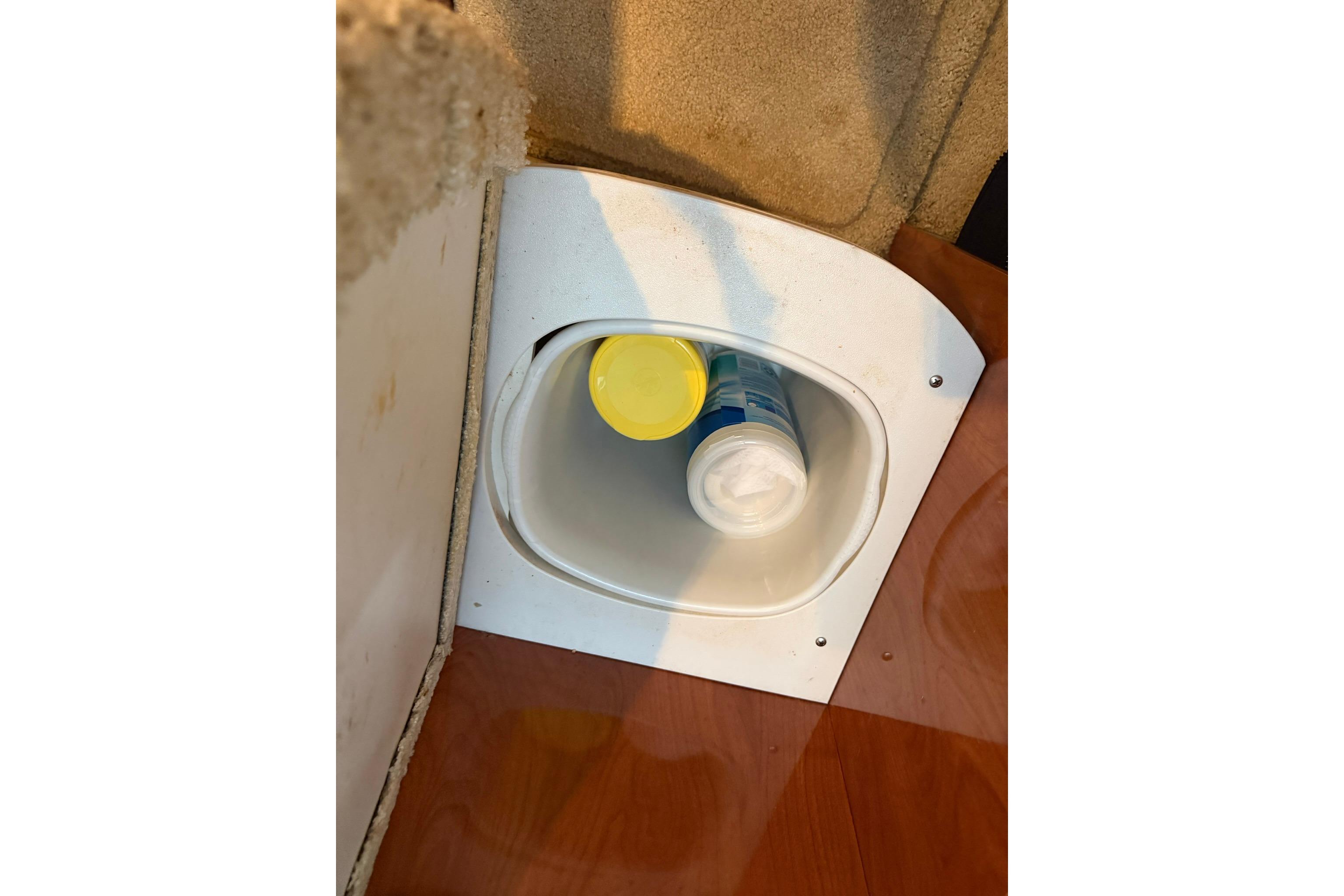 Cup holder with bottles inside a 2008 Four Winns V248 boat interior.