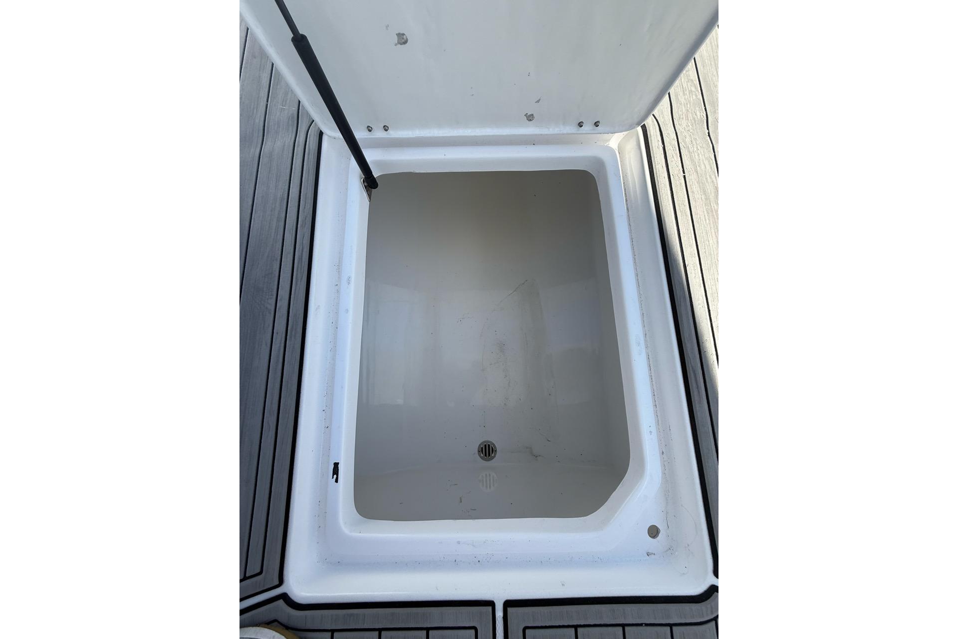 Open storage compartment on 2021 Custom Infusion 34 CC boat deck.