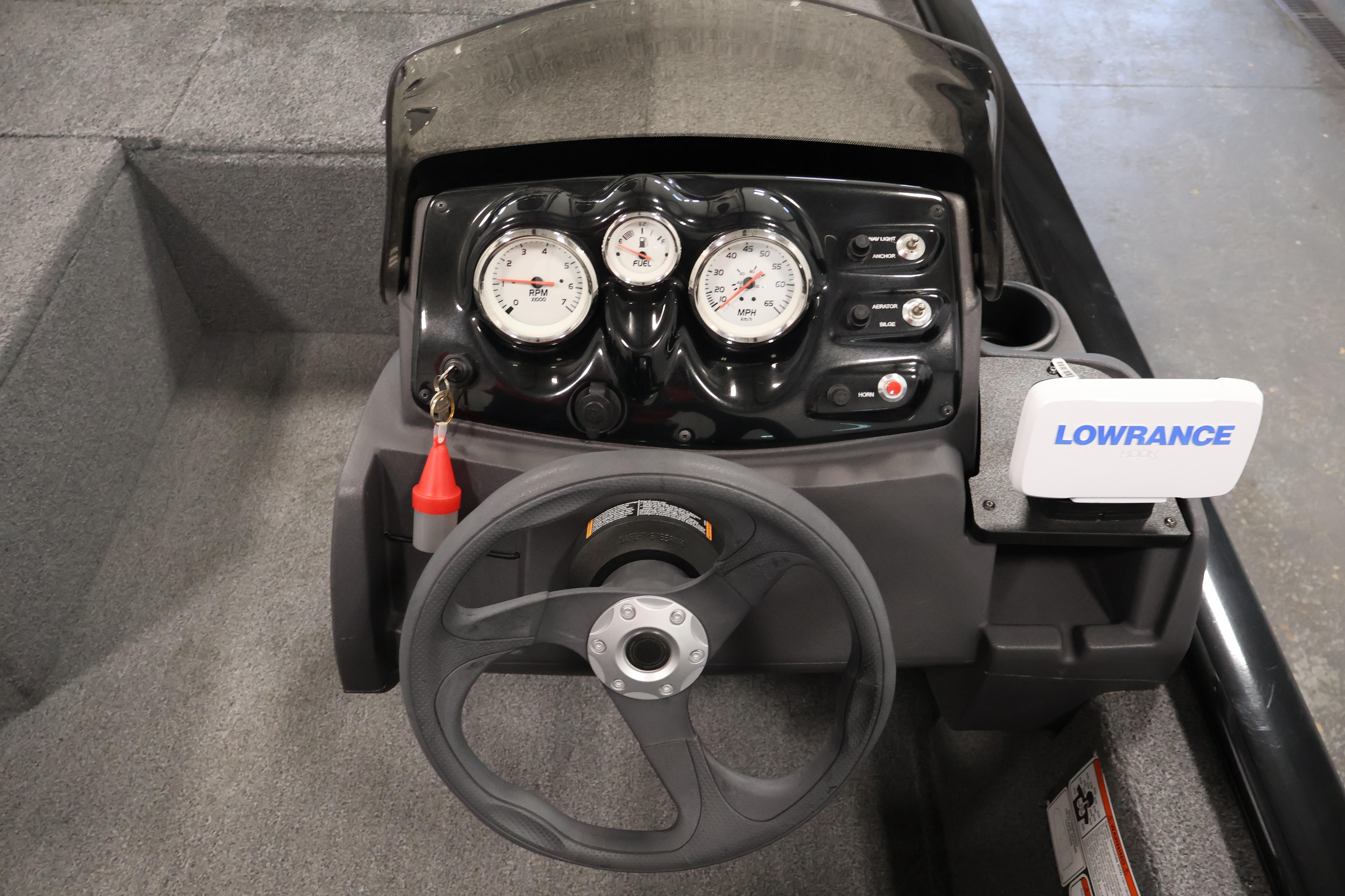 2024 Tracker Pro 170 boat dashboard with steering wheel and Lowrance navigation system.