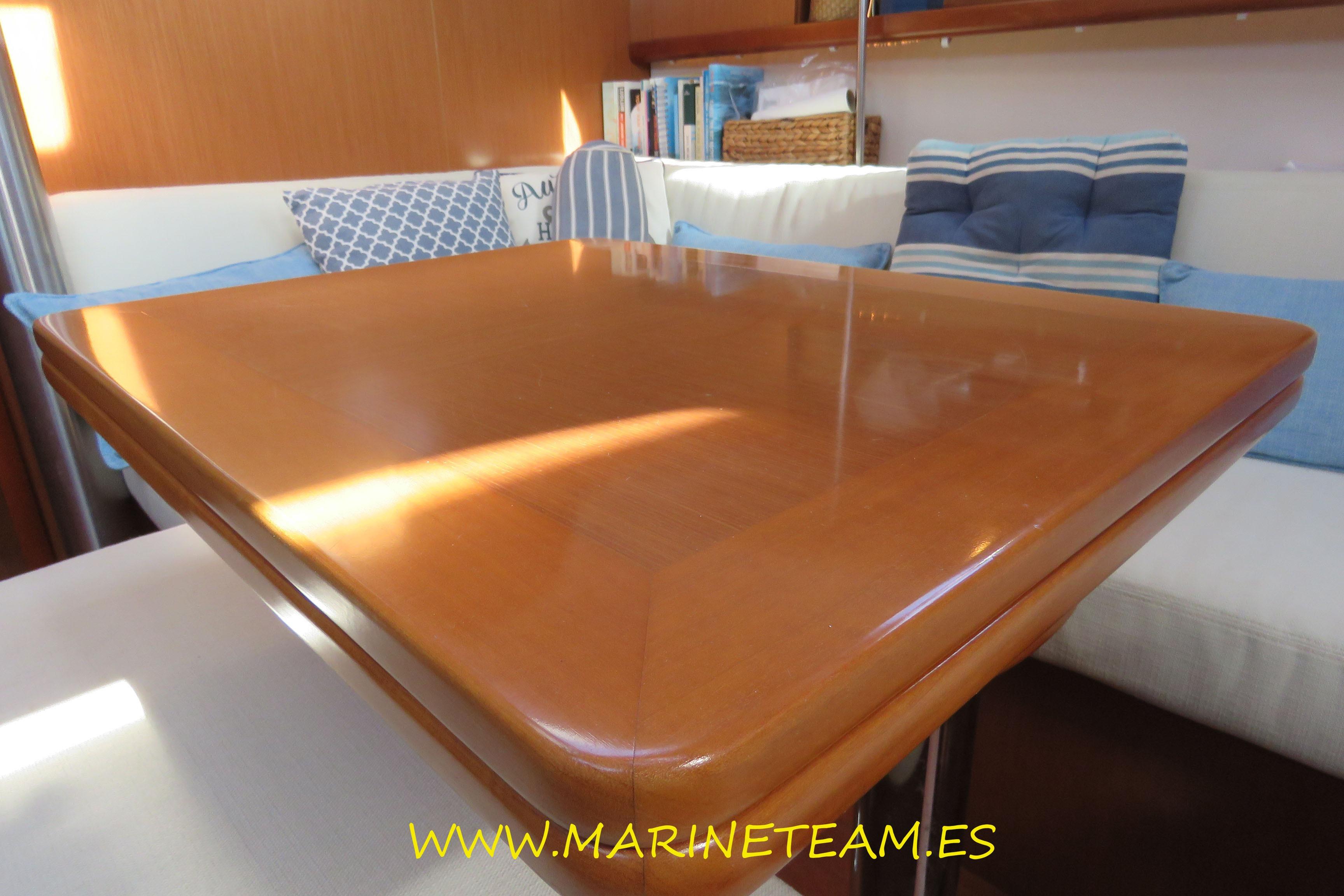 Interior of 2007 Beneteau Oceanis 40 yacht with wooden table and cushioned seating.