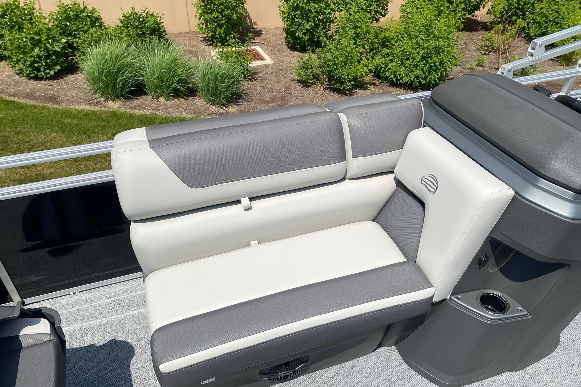 2026 Sun Tracker Fishin' Barge 20 DLX boat seating with gray and white upholstery.
