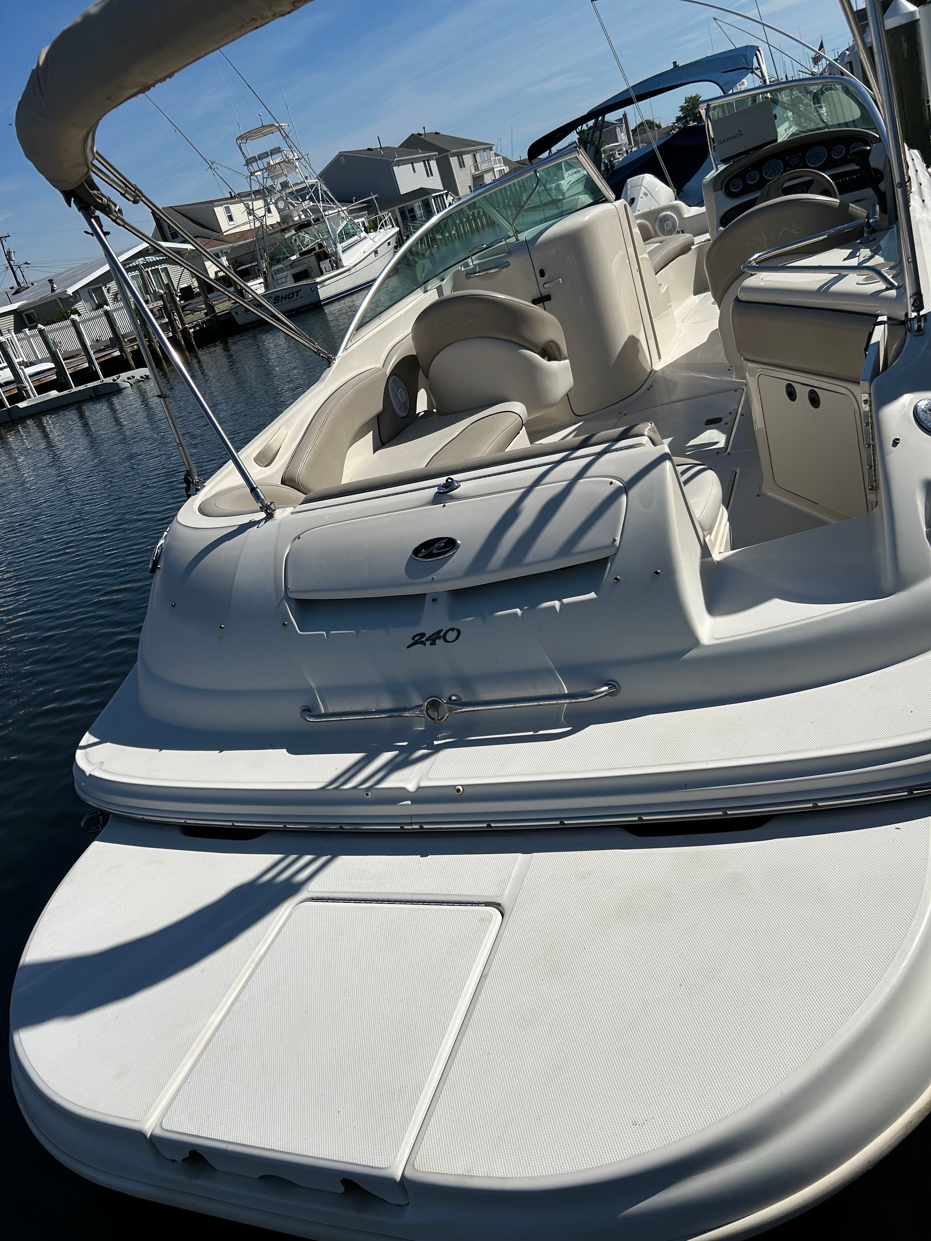 2003 Sea Ray 240 Sundeck boat docked.