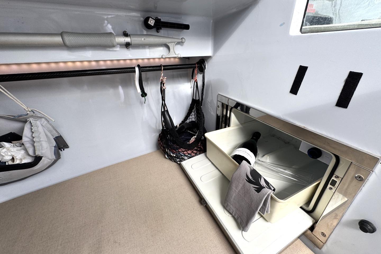 Interior of 2009 Wally Wallynano 37 yacht with storage and wine bottle.