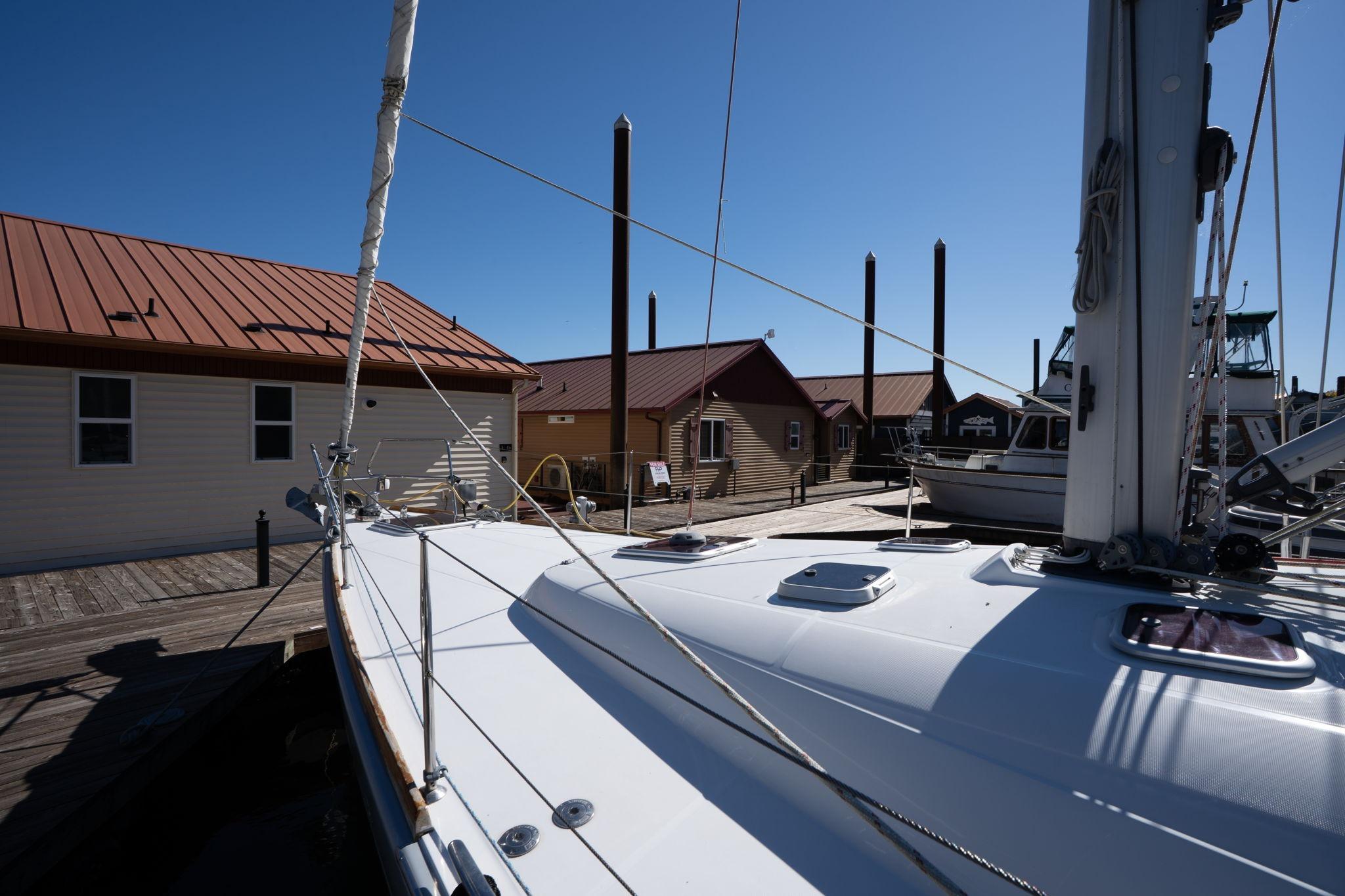 2013 Beneteau Oceanis 50 sailboat docked at marina under clear blue sky.