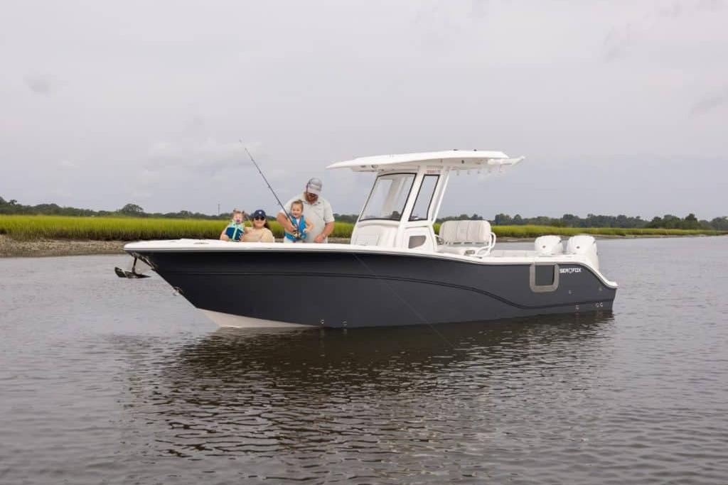 2027 Sea Fox 268 Commander boat with family fishing on calm waters.