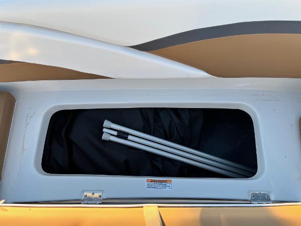 Storage compartment of 2024 Starcraft SVX 191 boat with poles inside.