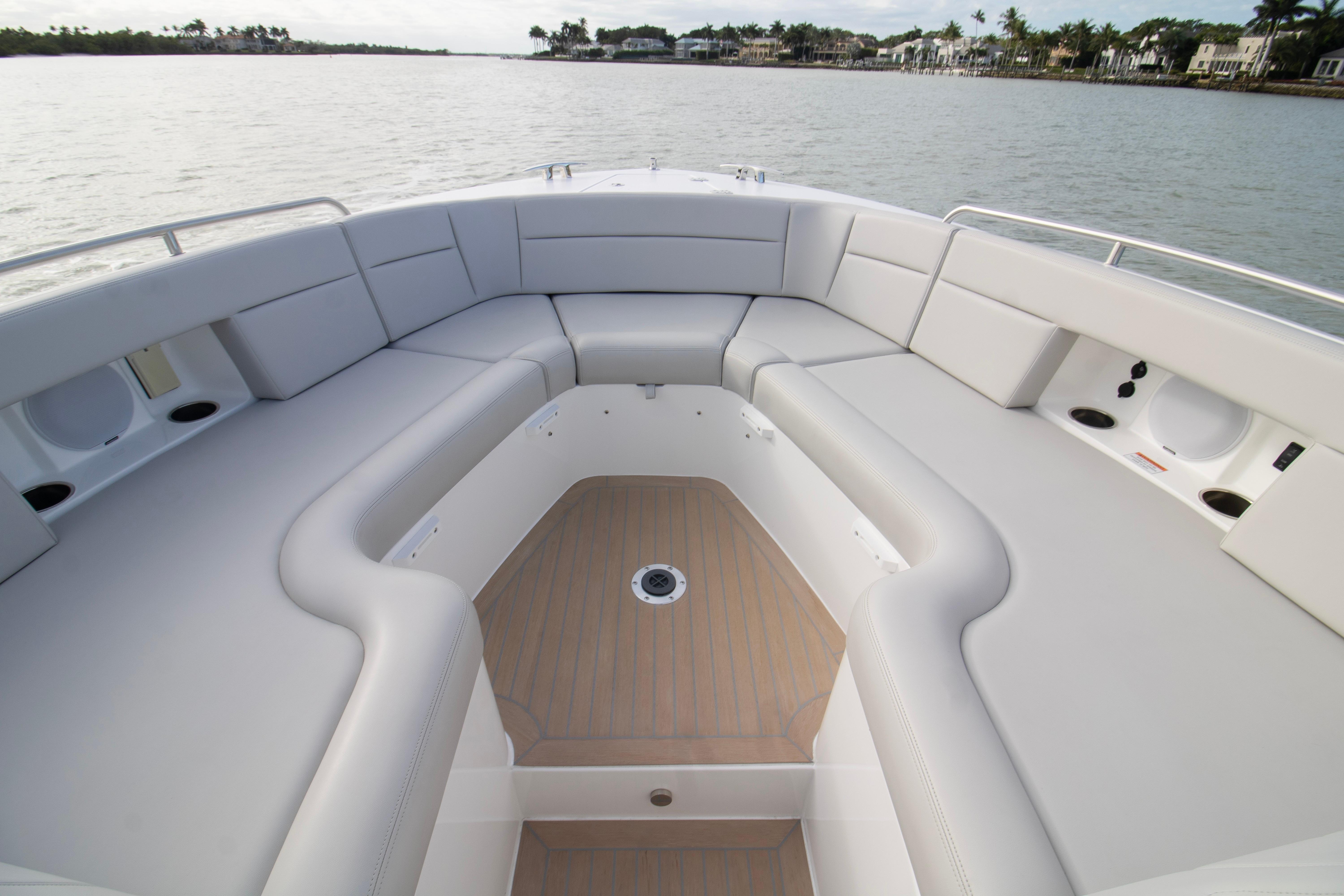 Spacious seating area on 2025 MJM 38 X boat, featuring elegant design and waterfront view.