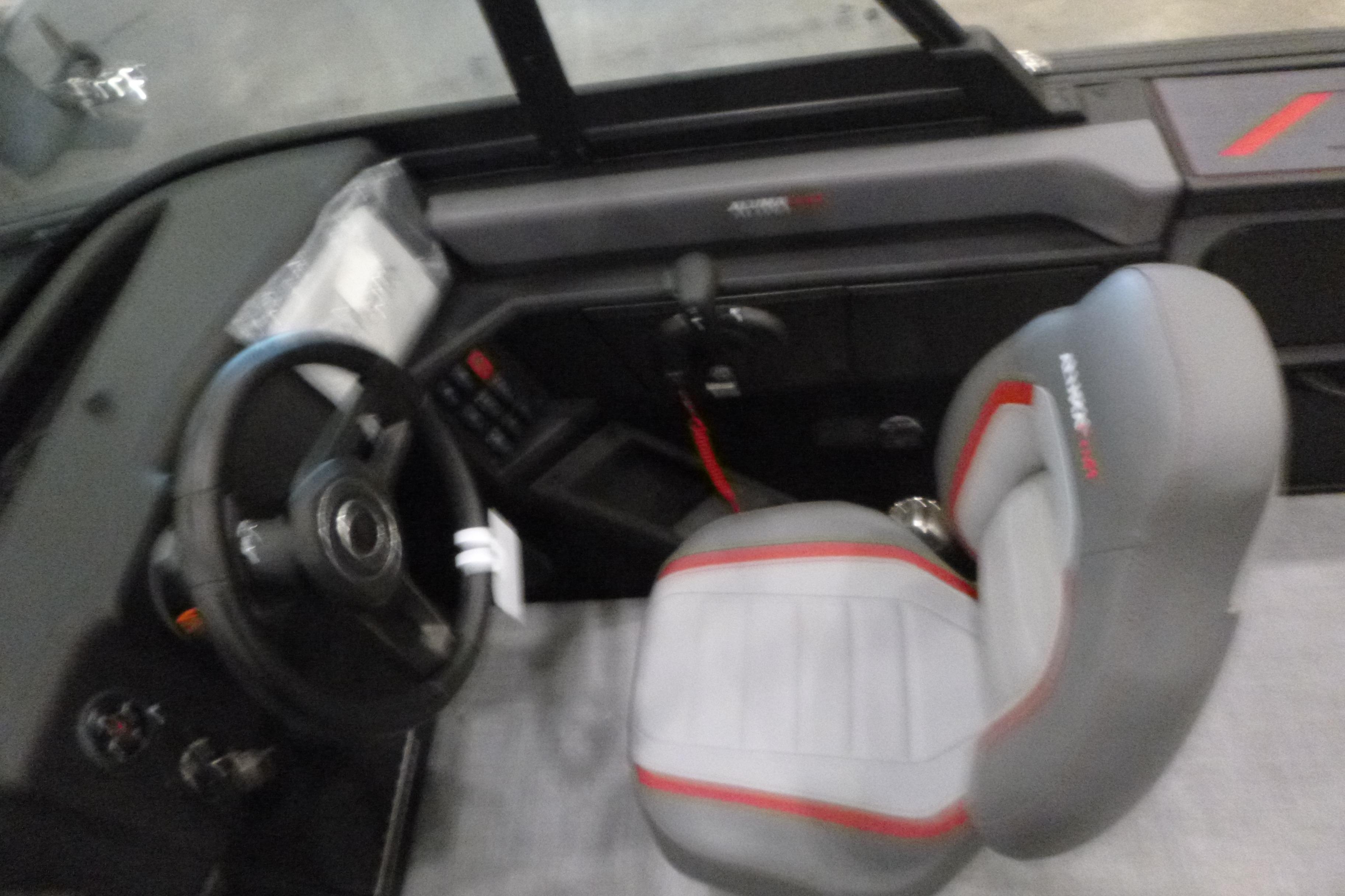 2025 Alumacraft Trophy 185X Sport boat interior with steering wheel and seat.