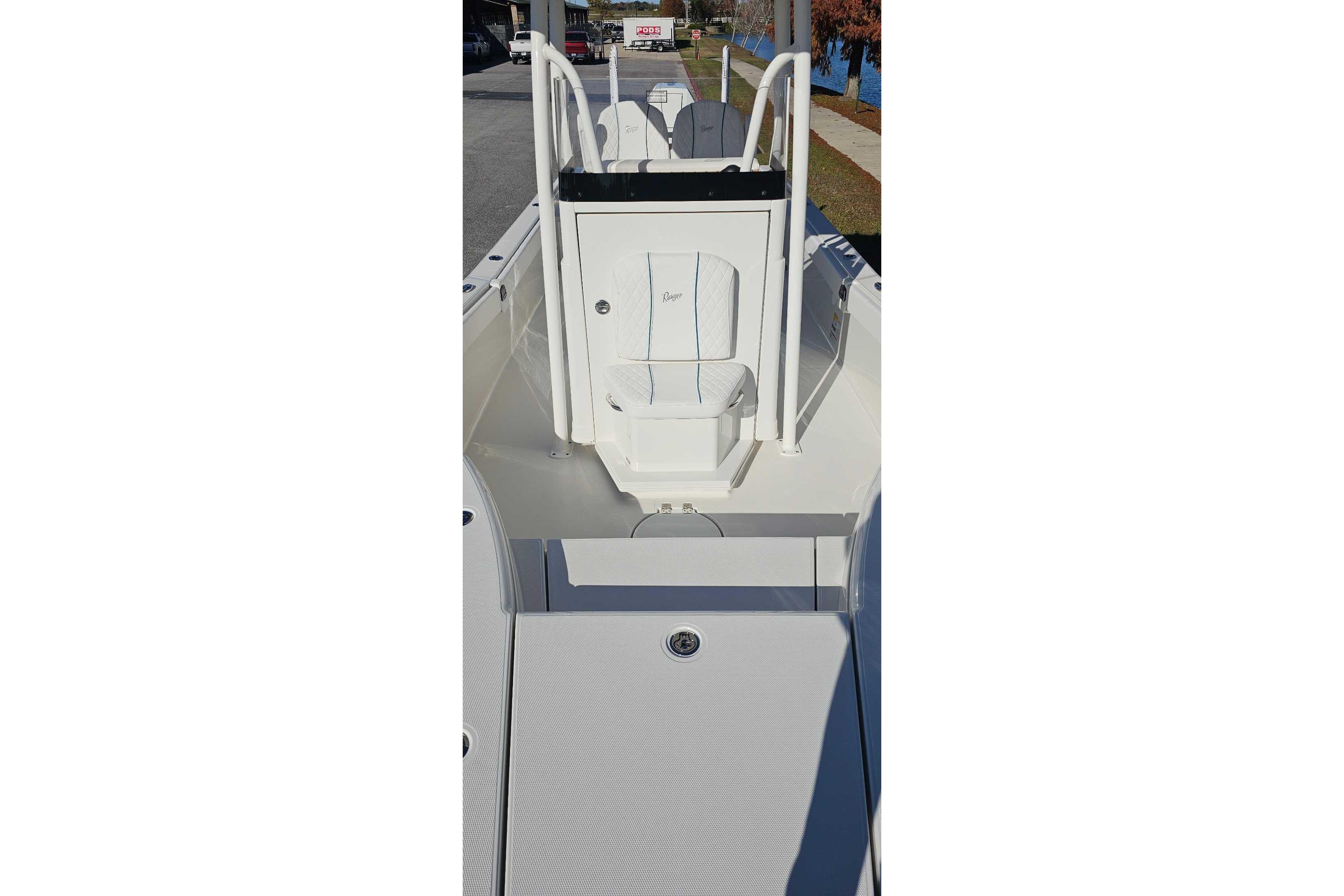 2026 Ranger 2660 Bay boat interior with seating and console, docked outdoors.