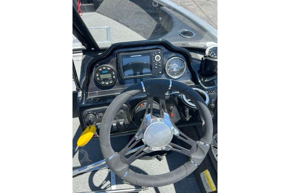Dashboard of 2023 Starweld Fusion 18 DC boat with steering wheel and controls.