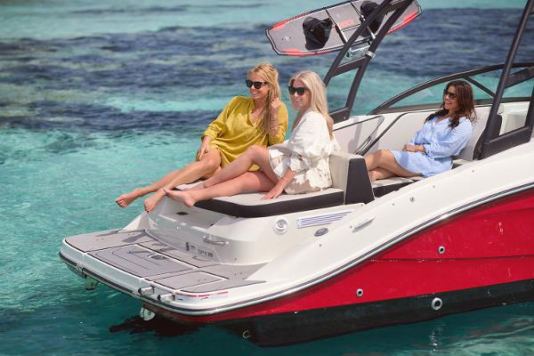 Manufacturer Provided Image: Three women relaxing on a 2025 Sea Ray SPX 210 boat in clear blue water.