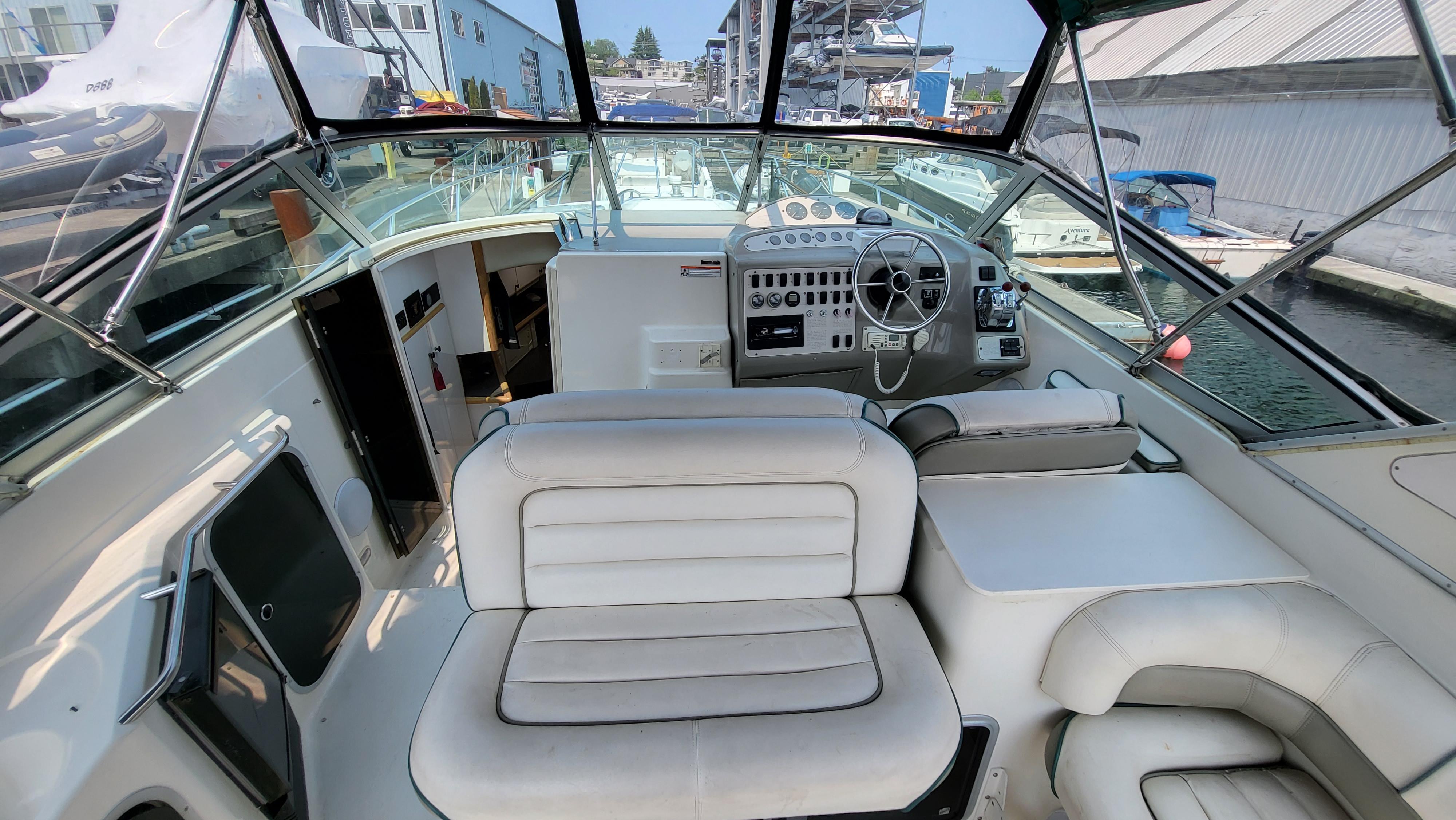1994 Maxum 3200 SCR boat interior with white seating and control panel.