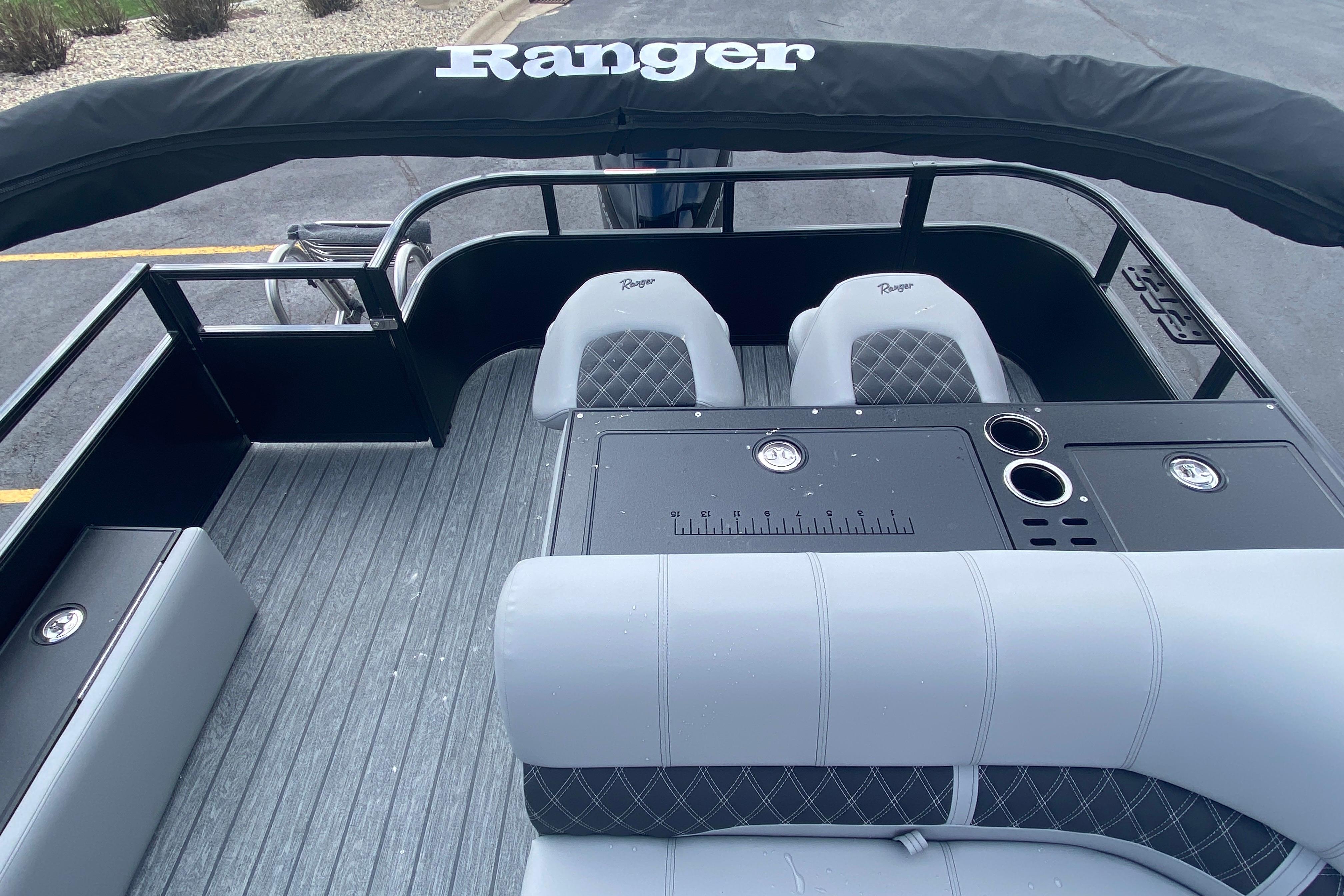 2026 Ranger 223FC boat interior with seating, console, and cup holders.