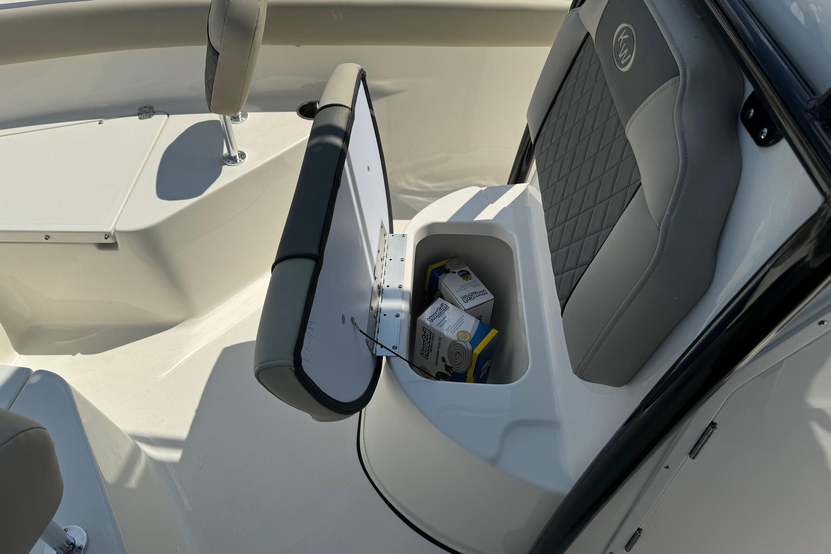 2025 Key West 203 FS boat interior with open storage compartment and seat.